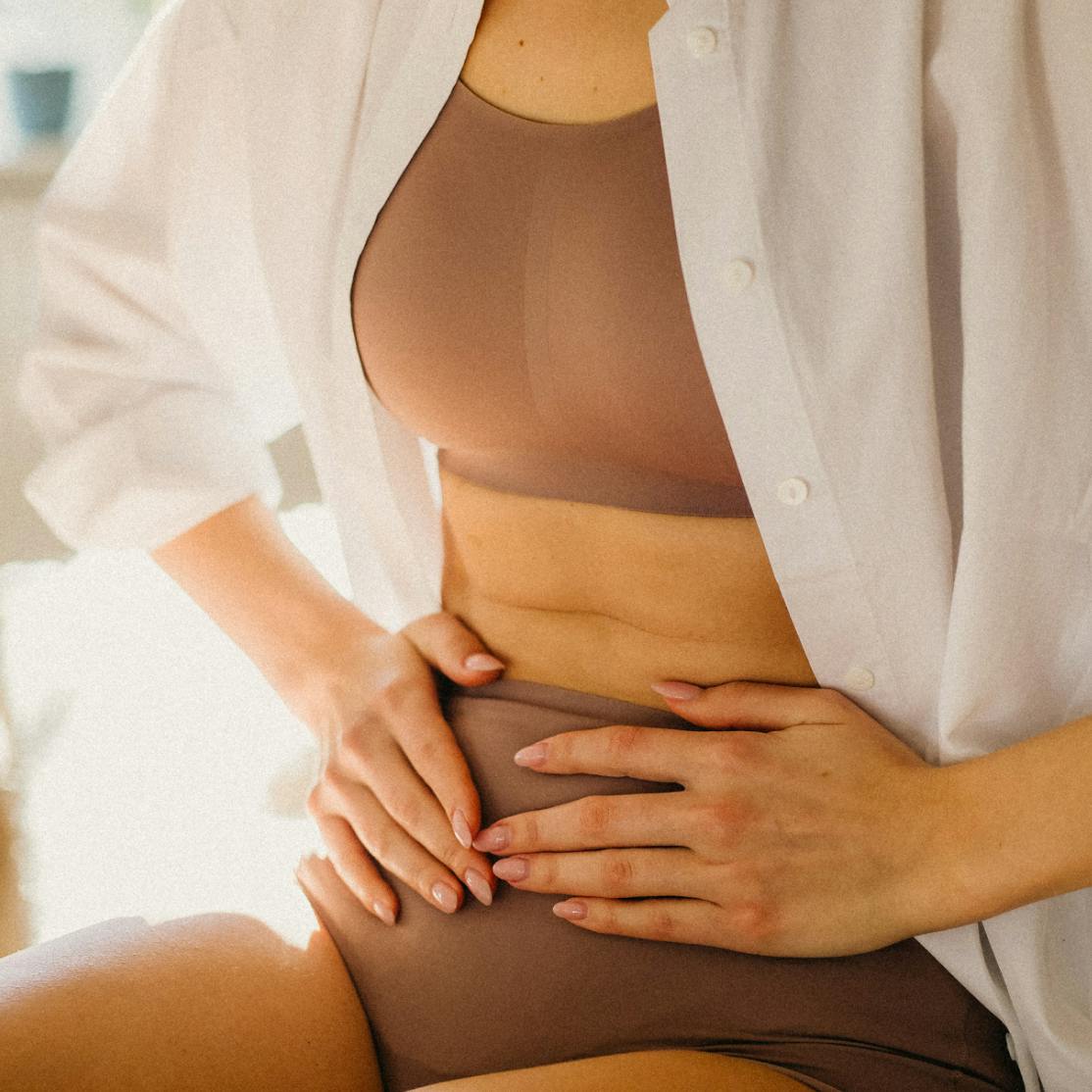 image of woman gripping lower abdomen