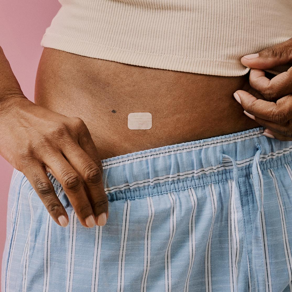 Woman in menopause wearing an HRT patch