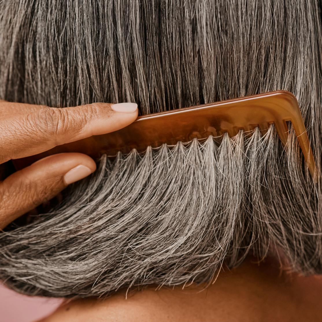 woman combing thick hair