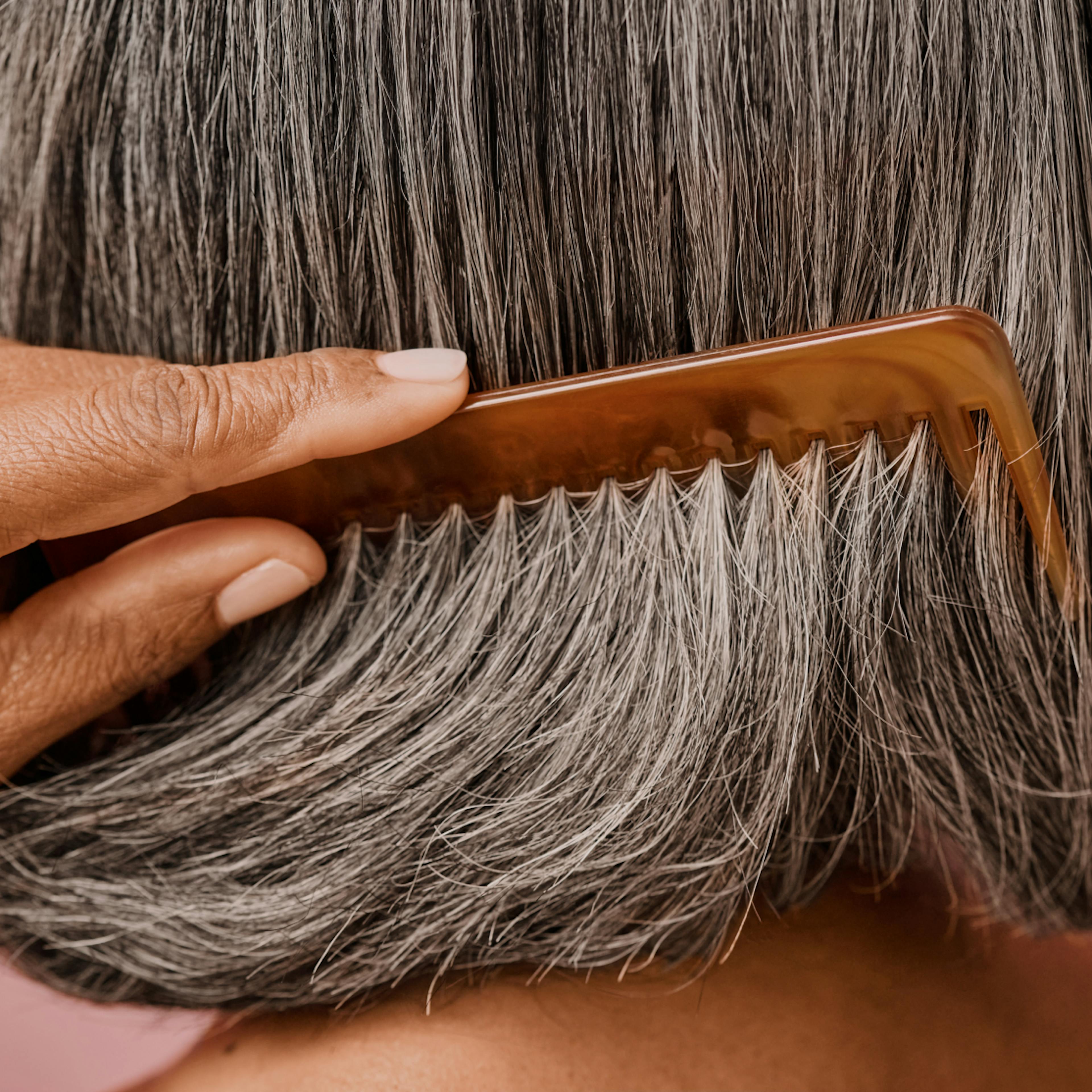 woman combing thick hair