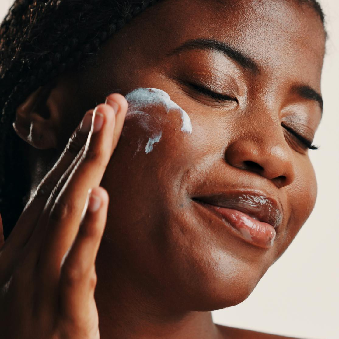 woman applying tretinoin on her cheek