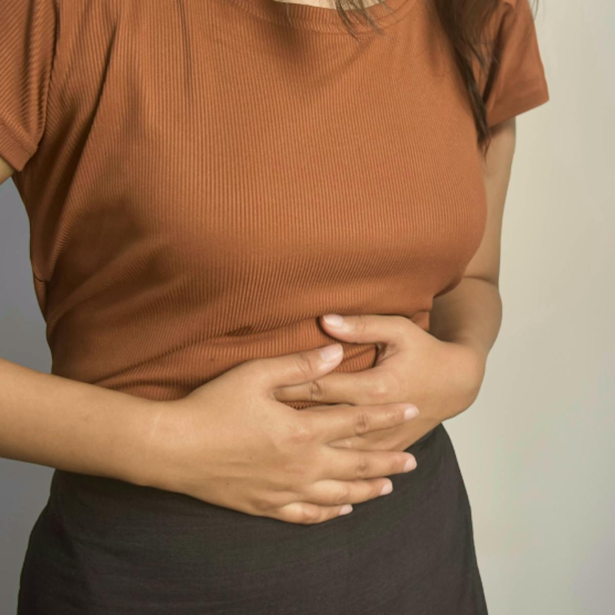 image of woman gripping stomach