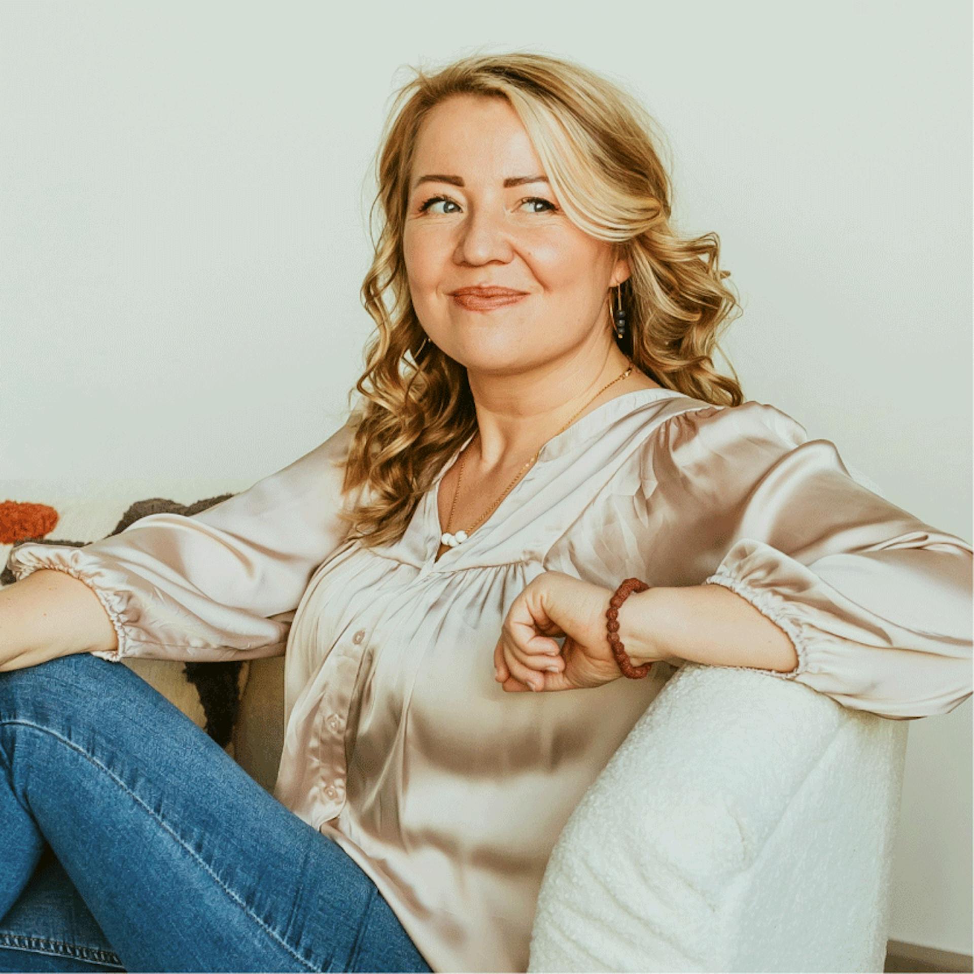 woman smiling sitting on a coach