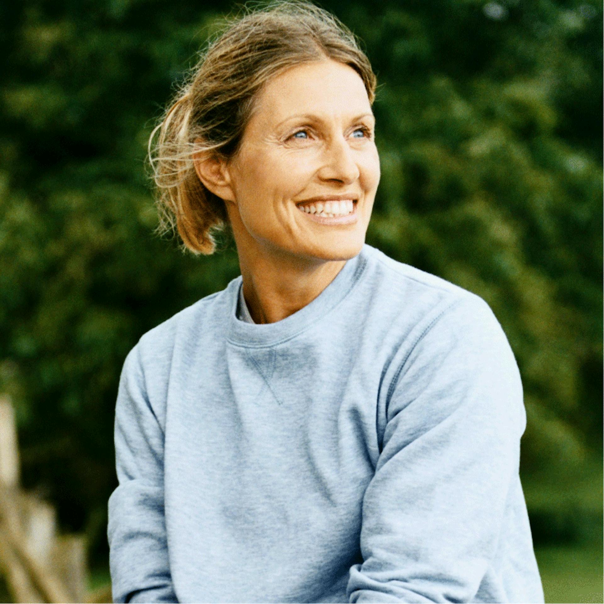 woman smiling looking off in the distance