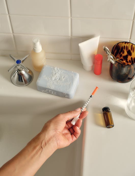 image of a woman with an injectable GLP-1