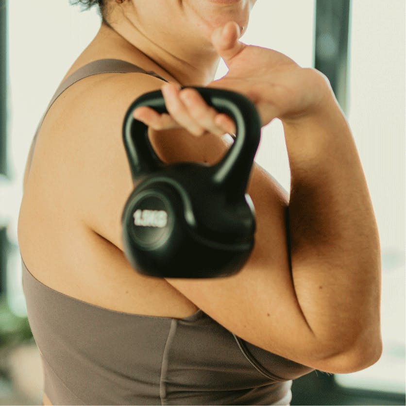 woman holding a kettlebell working out