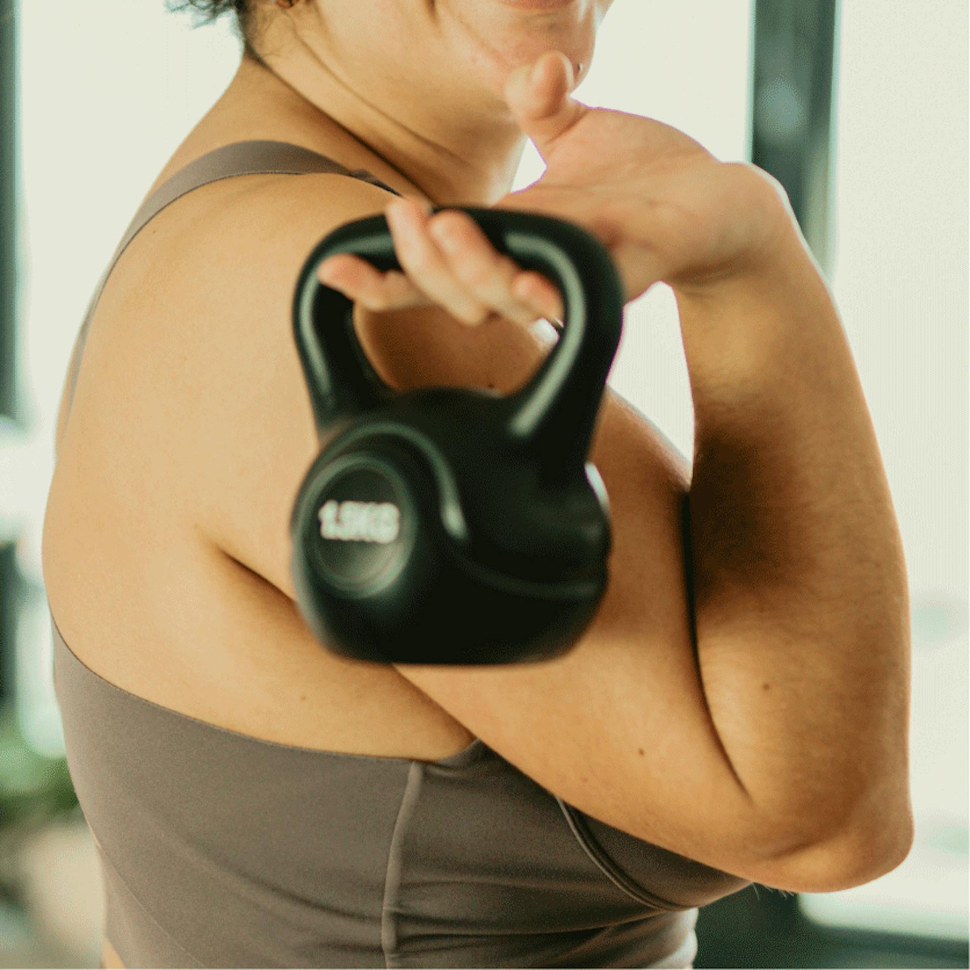 woman holding a kettlebell working out