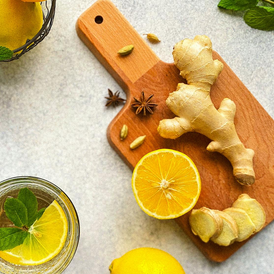 image of herbs for inflammation including a lemon and ginger on a cutting oard