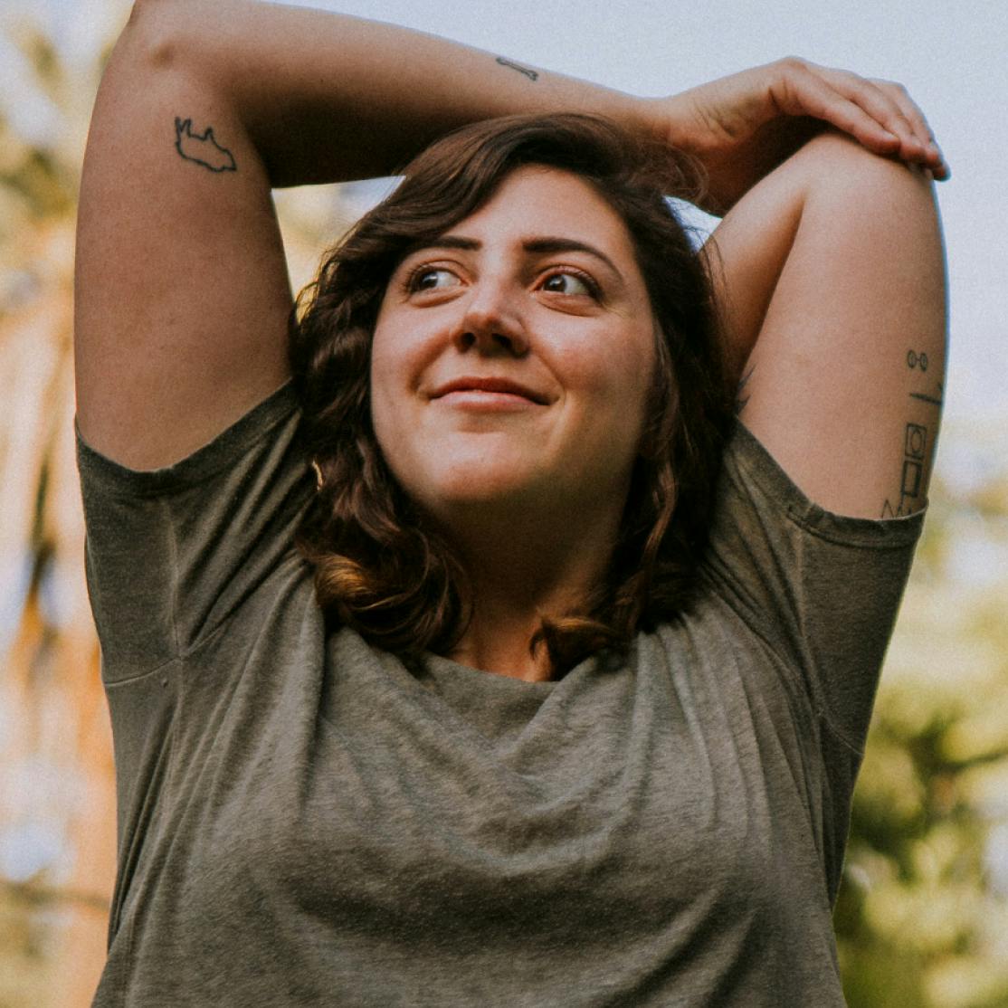woman stretching with arms overhead