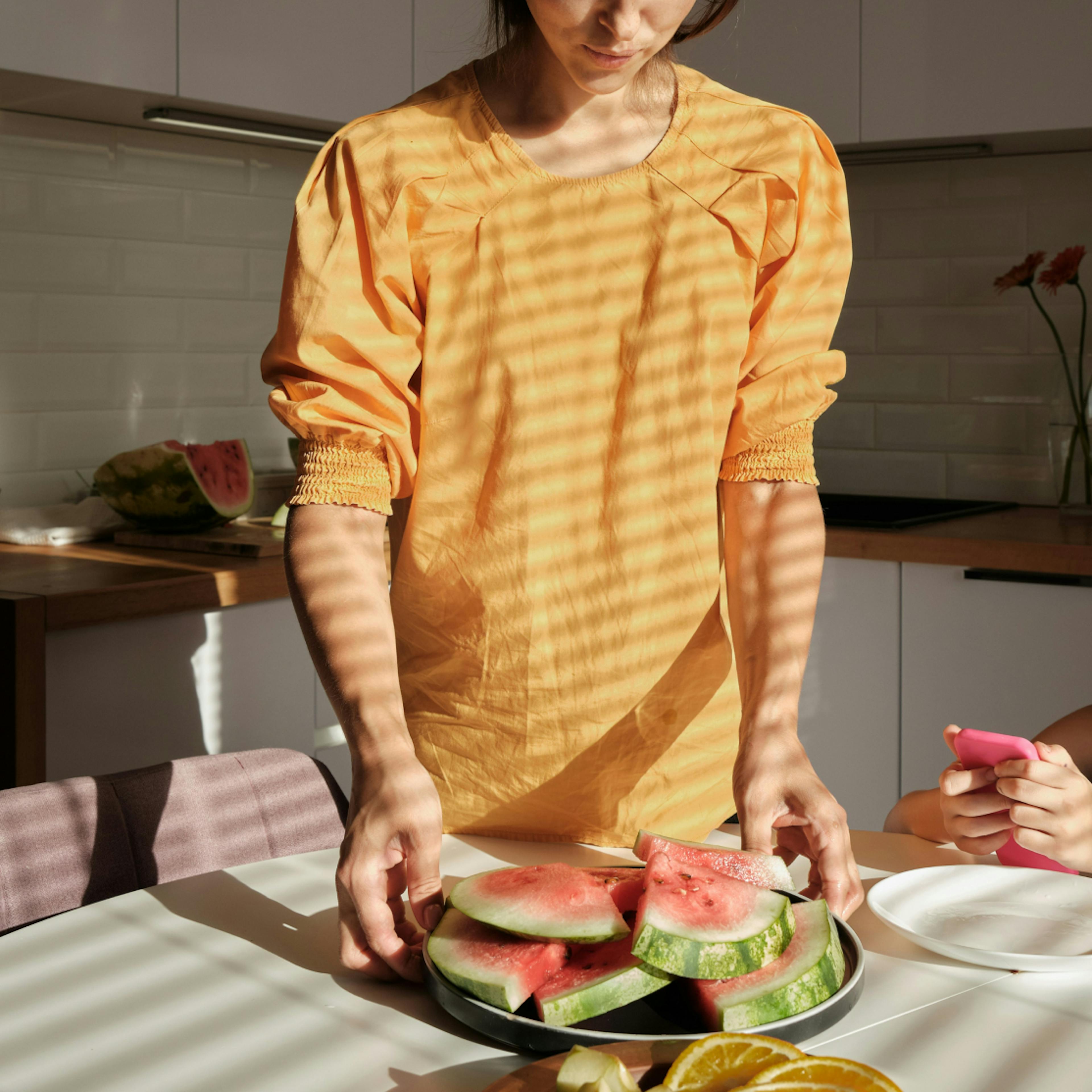 a woman with a plate of watermelon