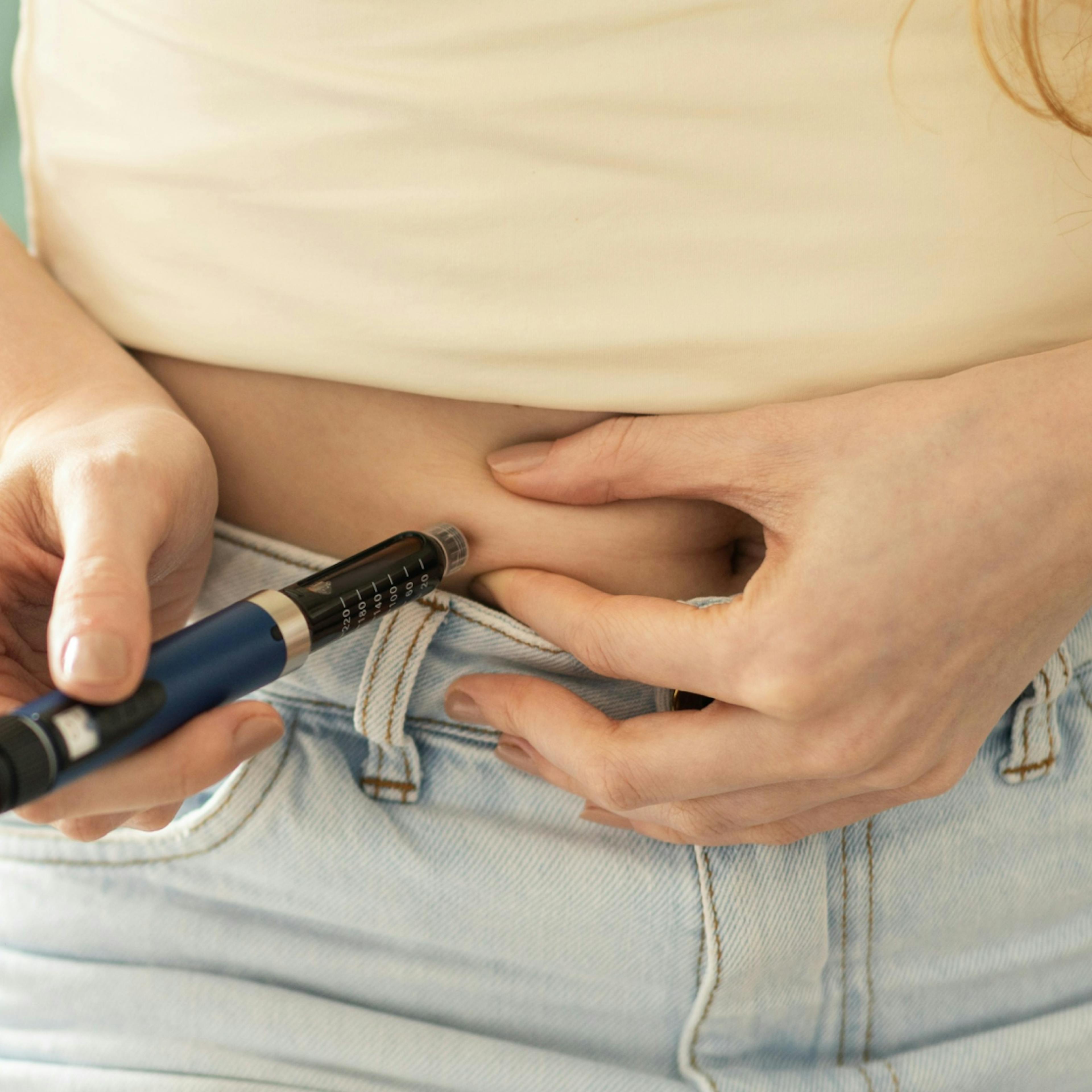 woman injecting herself with a GLP1