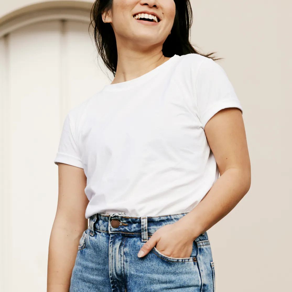 Woman standing and smiling looking in the distance