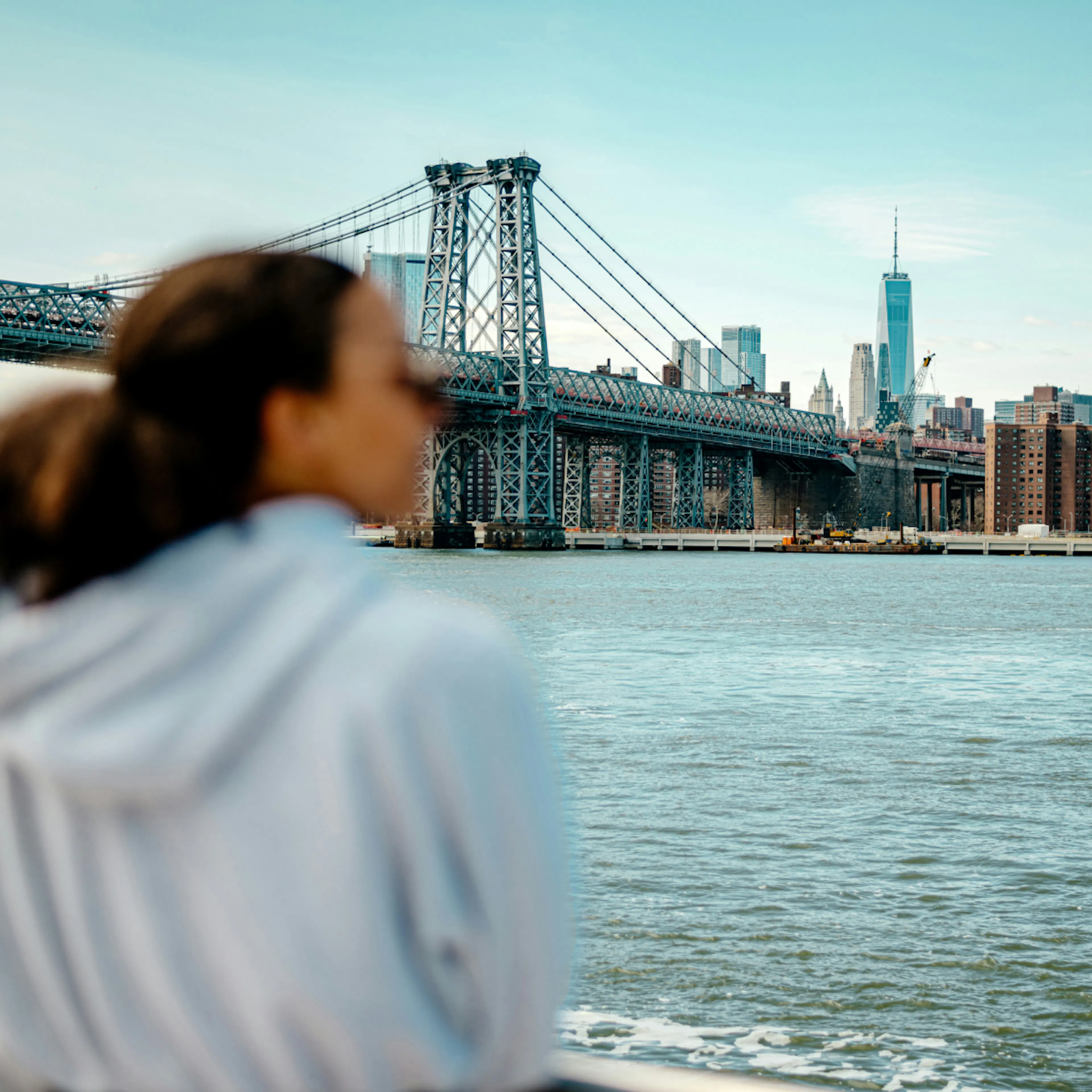 woman in perimenopause looking at the Brooklyn Bridge in New York