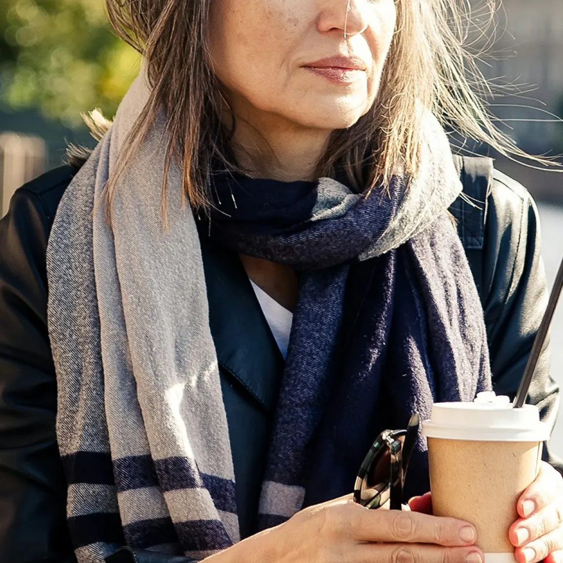 A close-up photo of a woman in midlife drinking a coffee as she considers the CJC-1295 peptide.