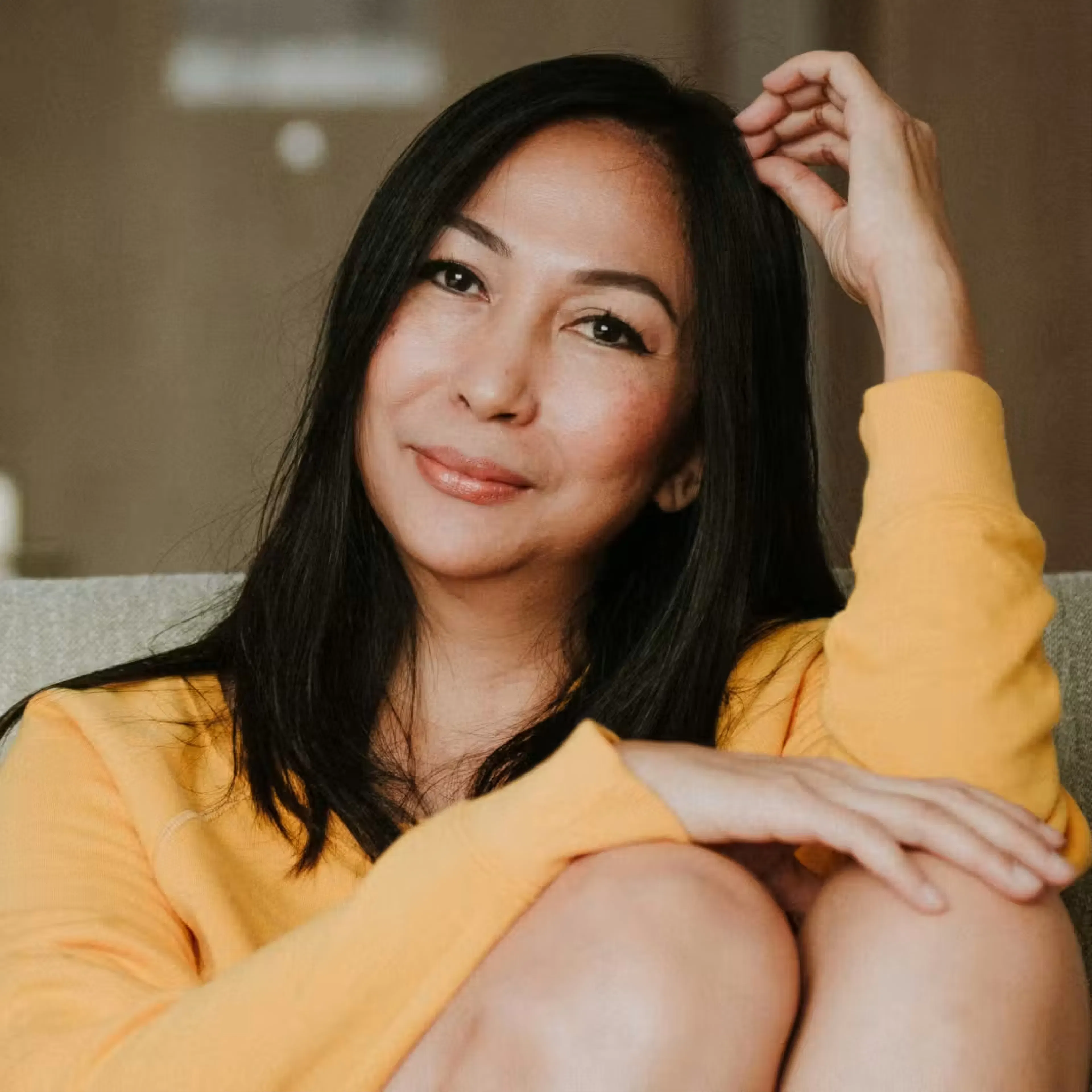Smiling woman wearing bright yellow sweater