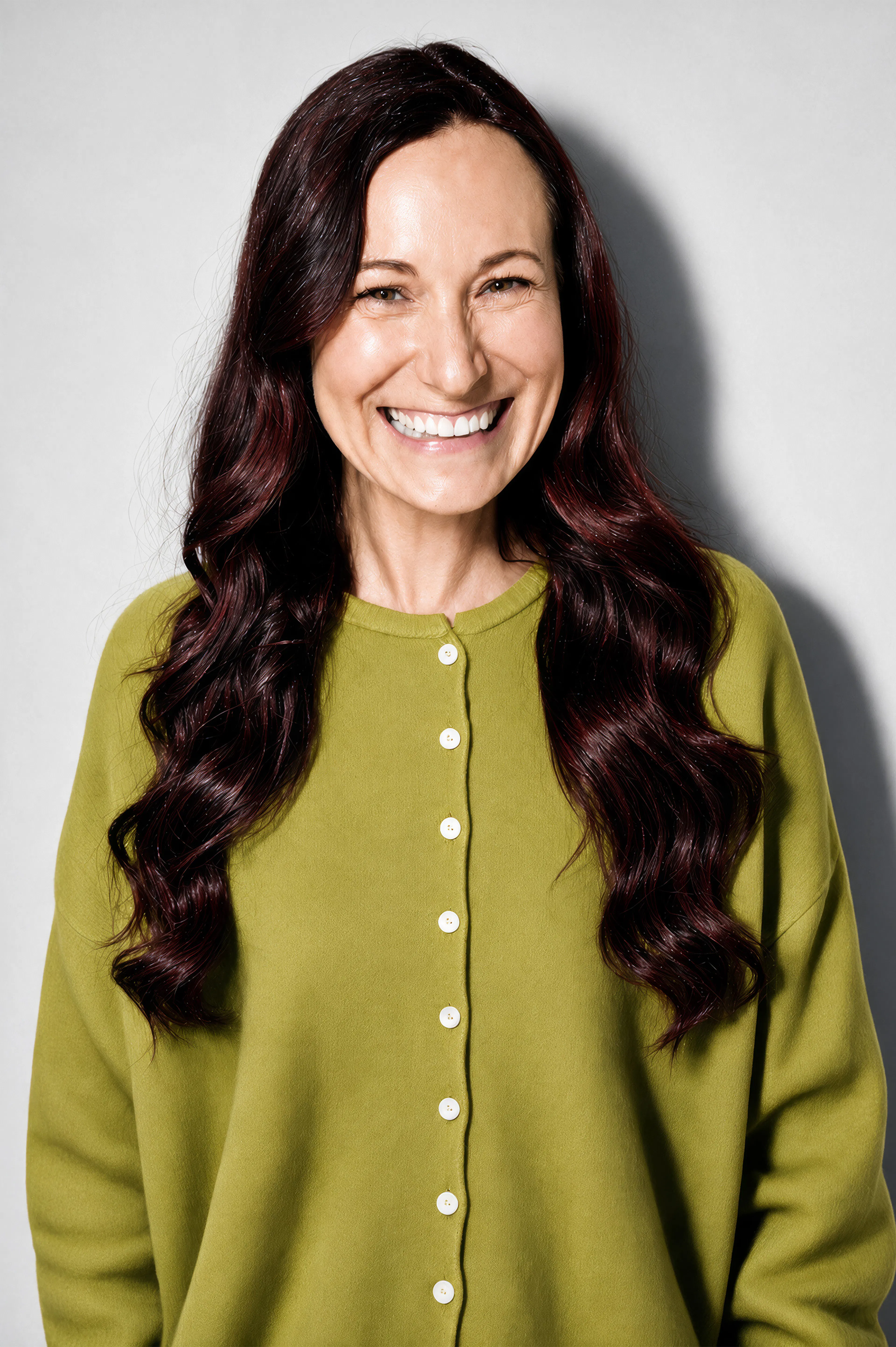 Smiling woman wearing a bright sweater