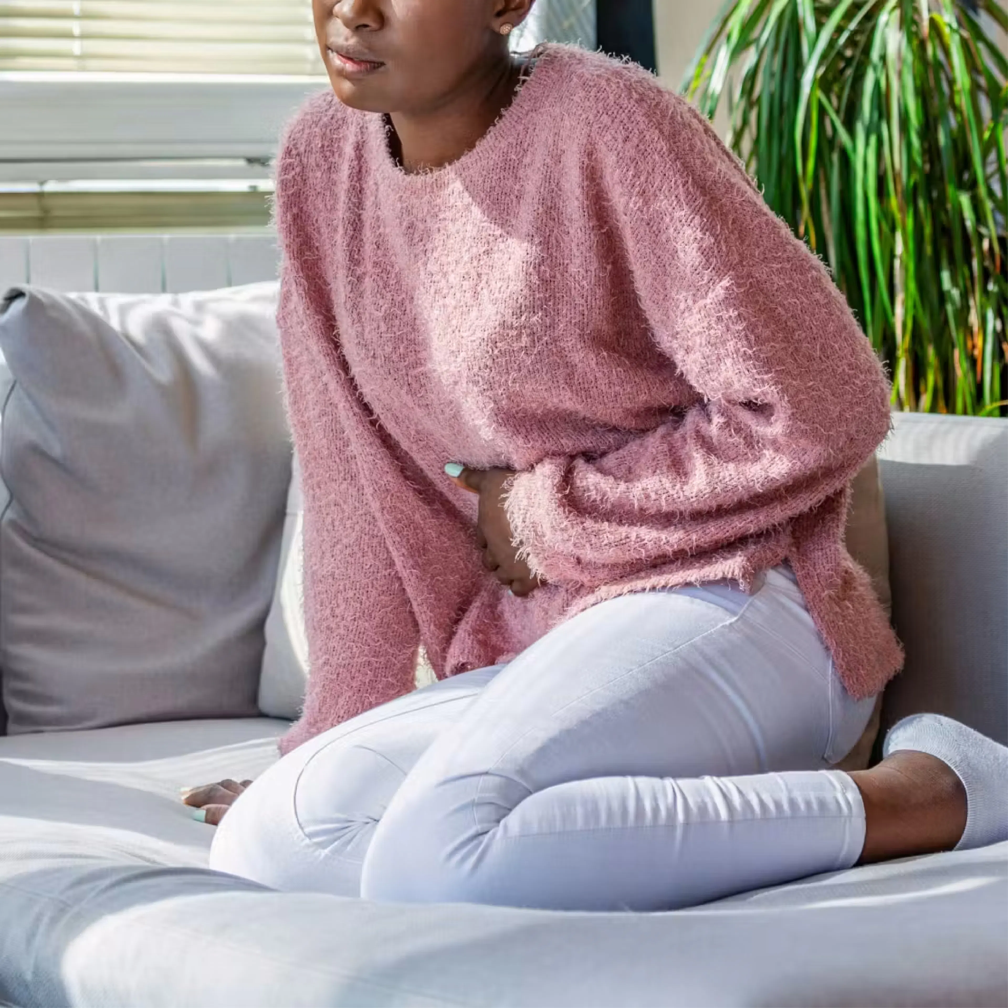 Woman holding her stomach in pain