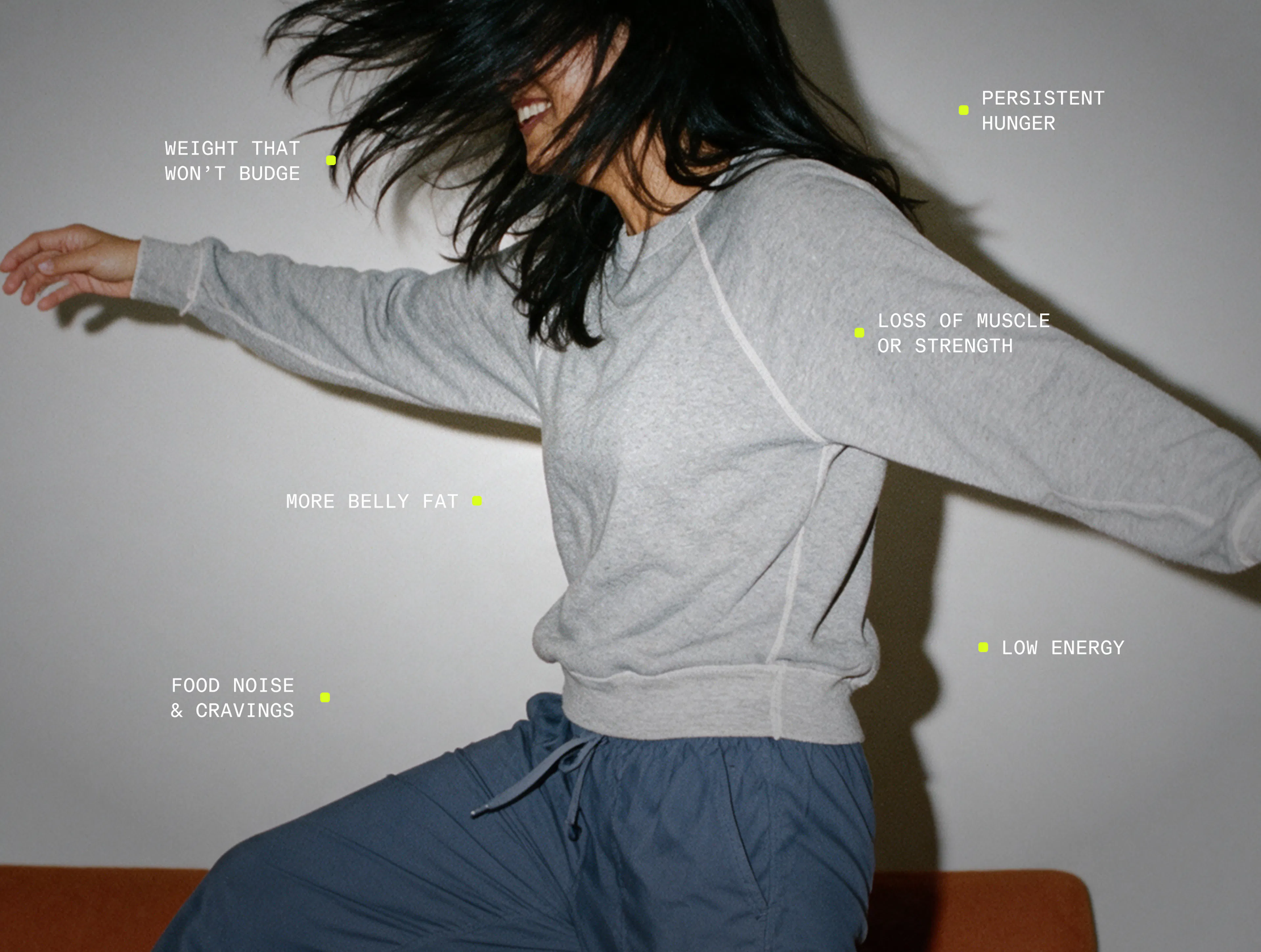 Woman moving playfully in gray sweatshirt