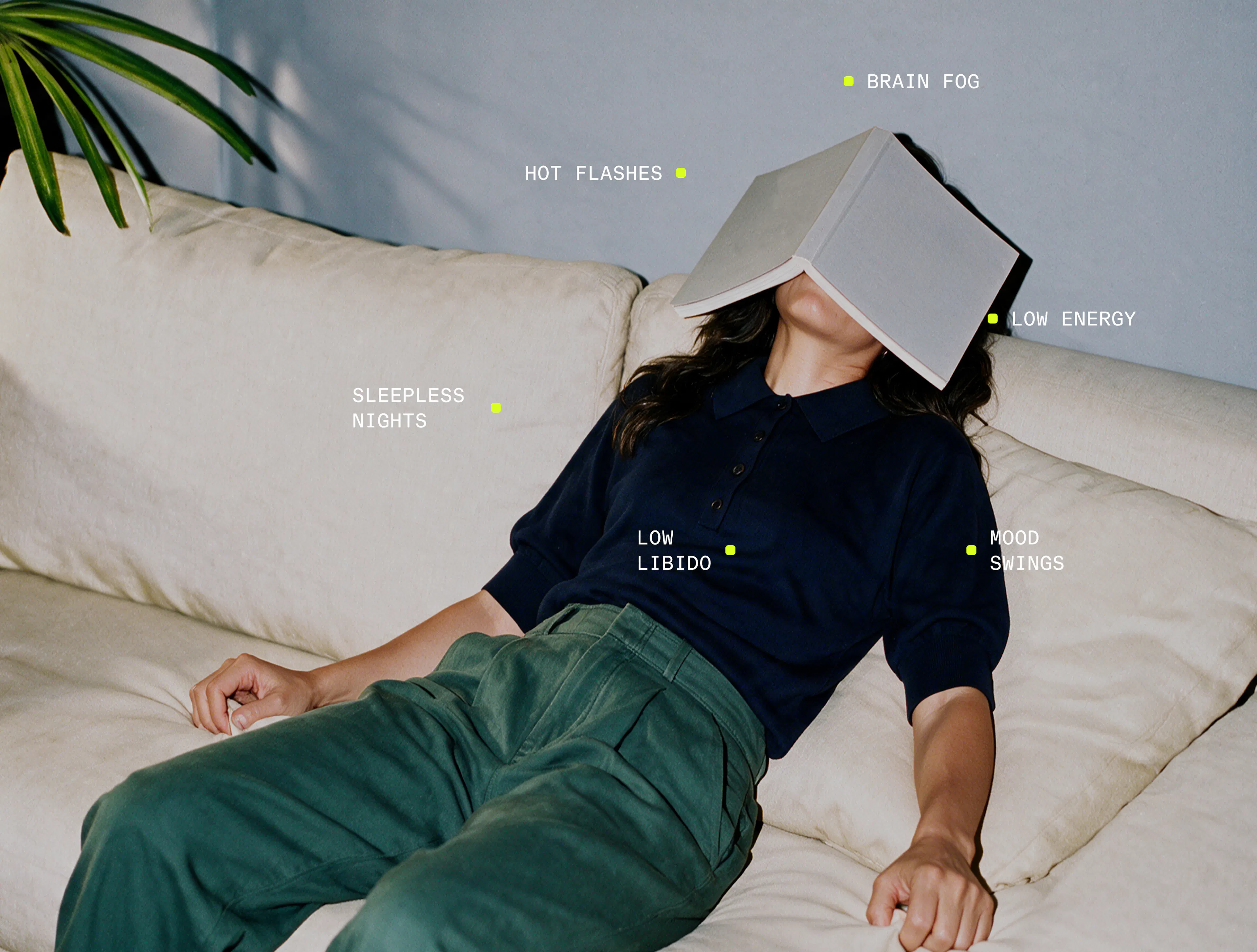 Woman lying down with book covering face