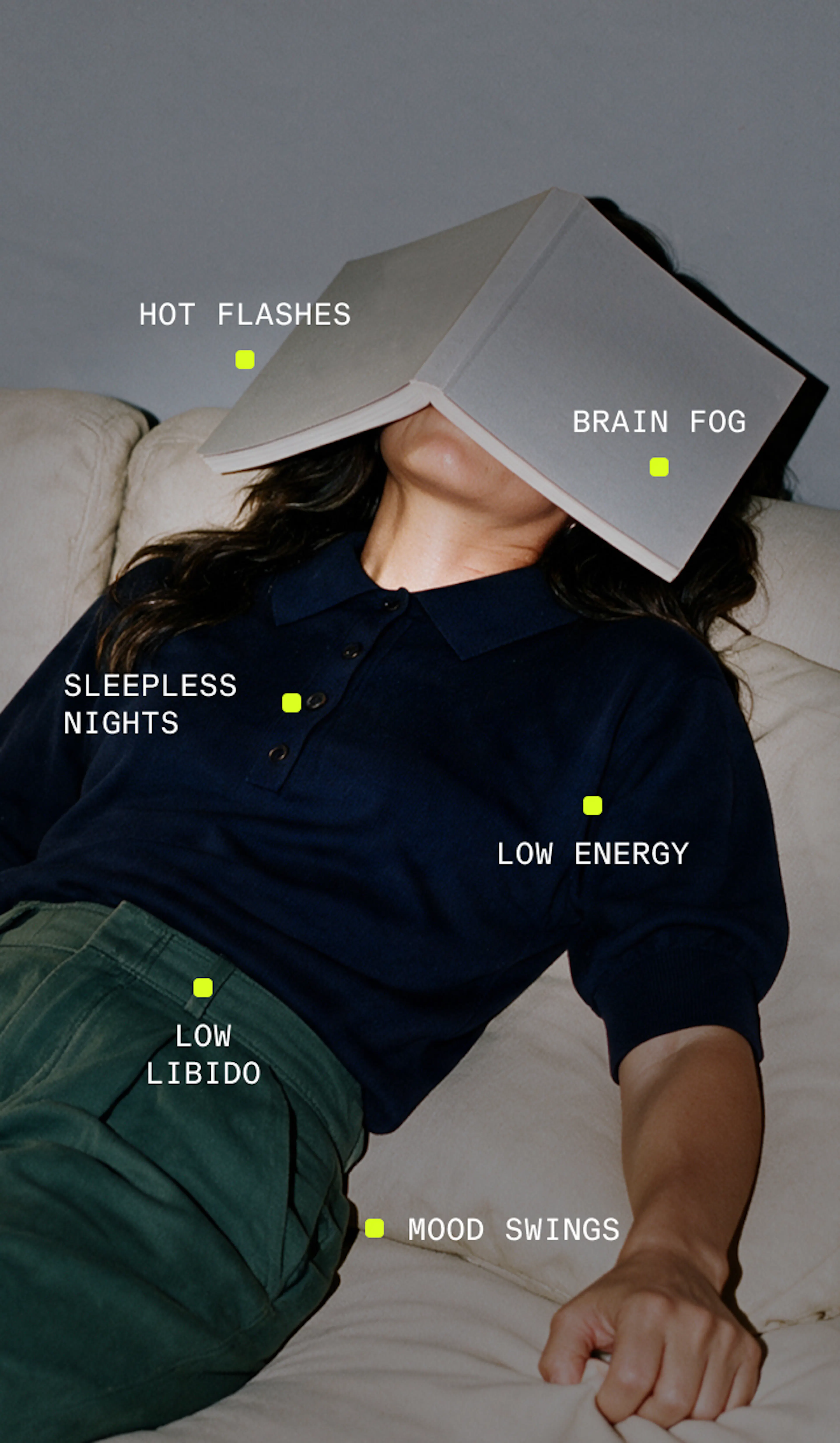 Woman lying down with book covering face