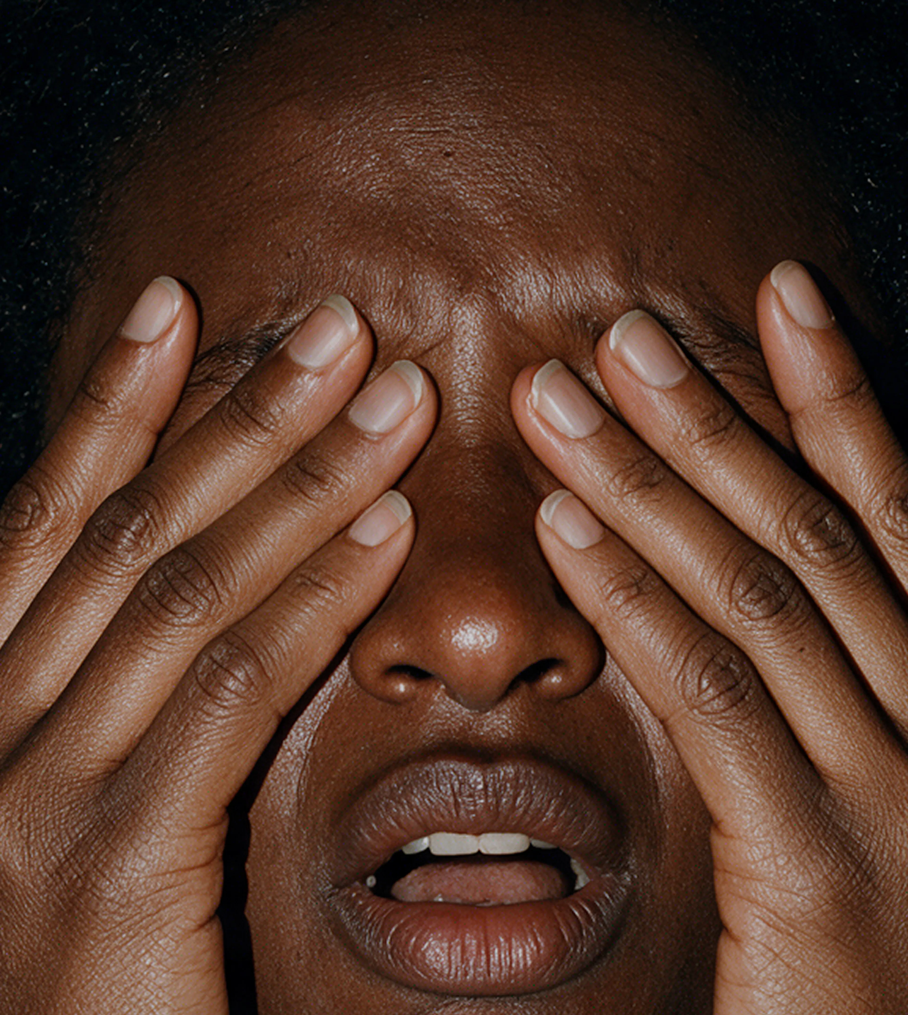 Woman covering her face in distress