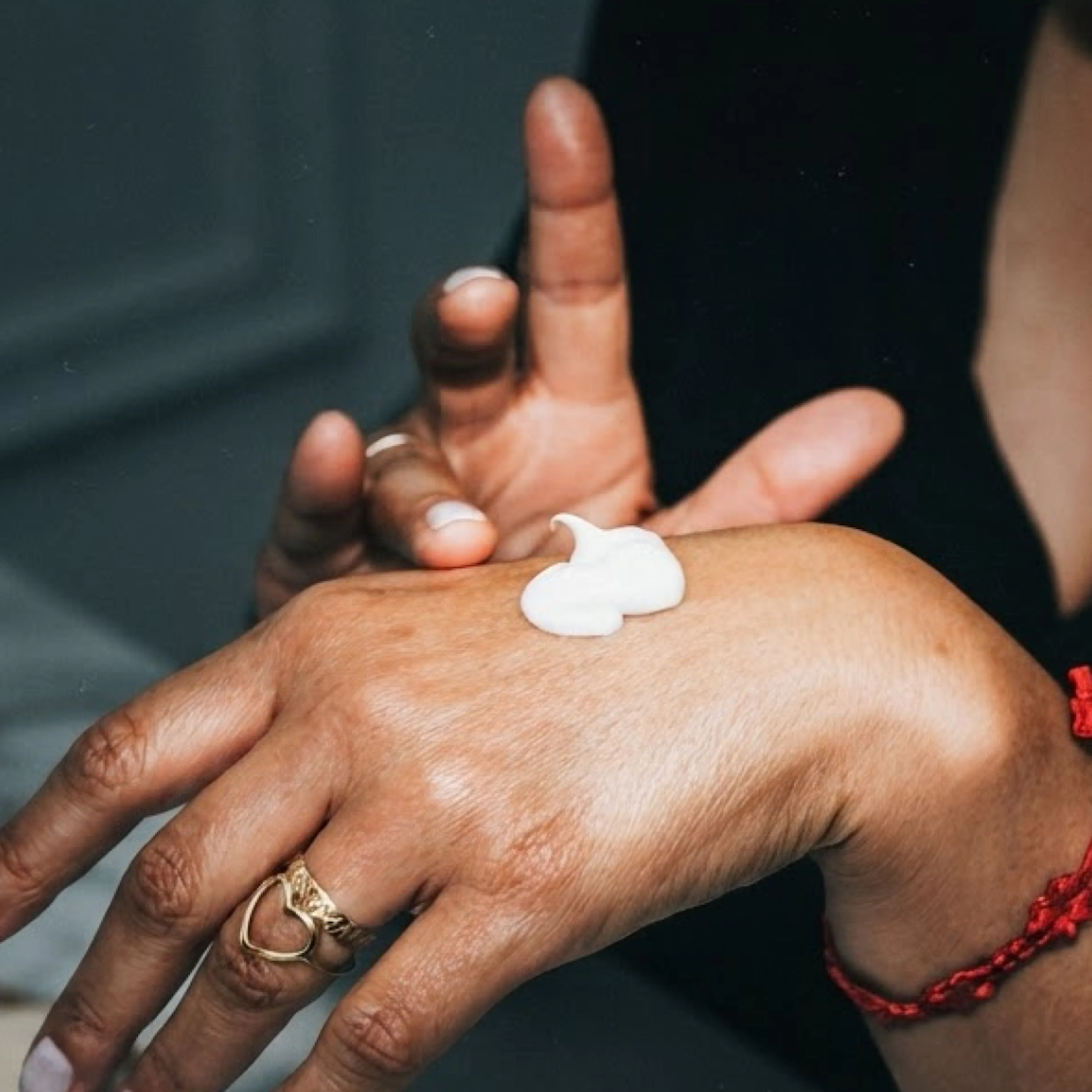 White cream on the back of a woman's hand.