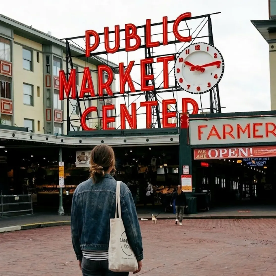 A woman in menopause walking in front of the Public Market Center in Seattle.