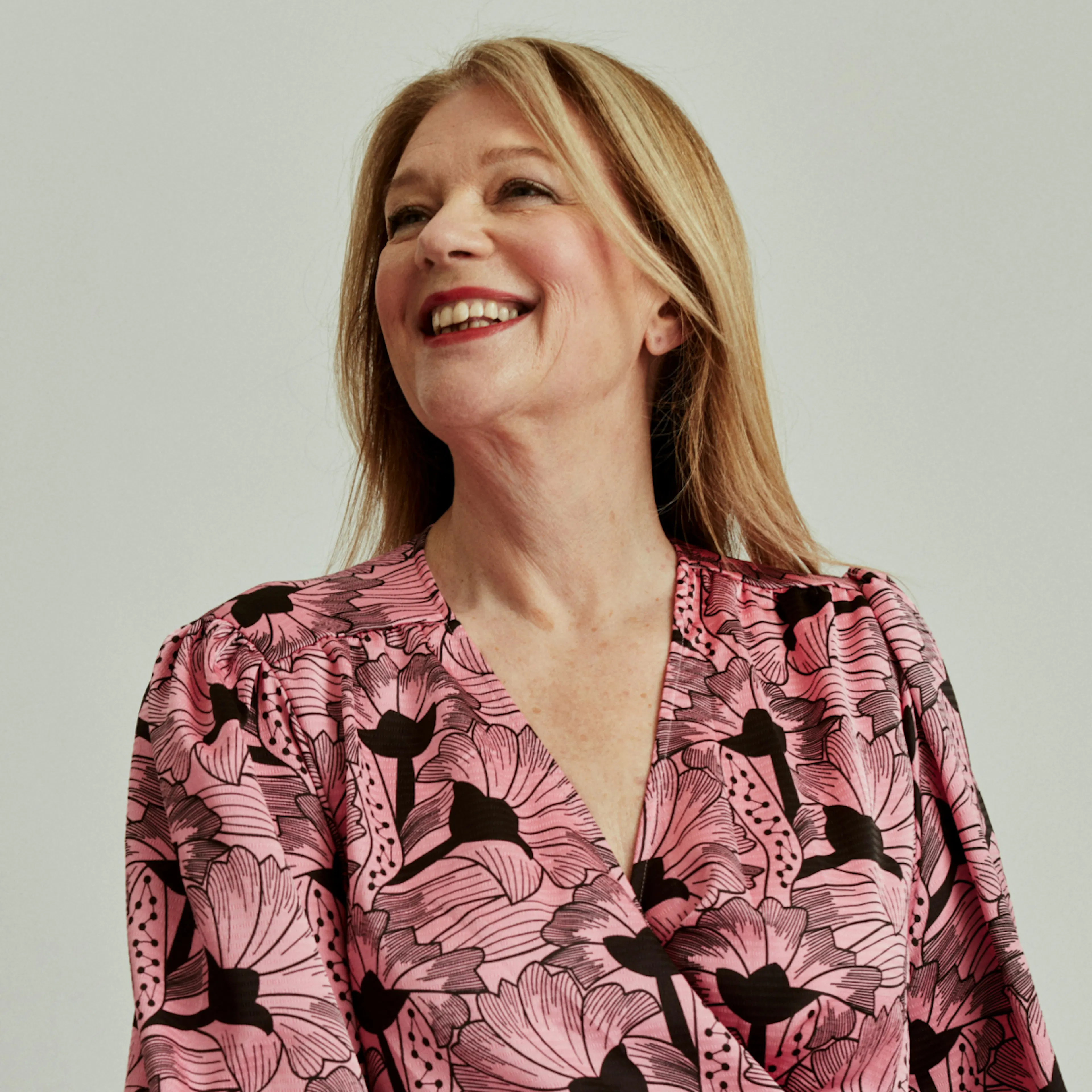 A woman in menopause smiling and looking up