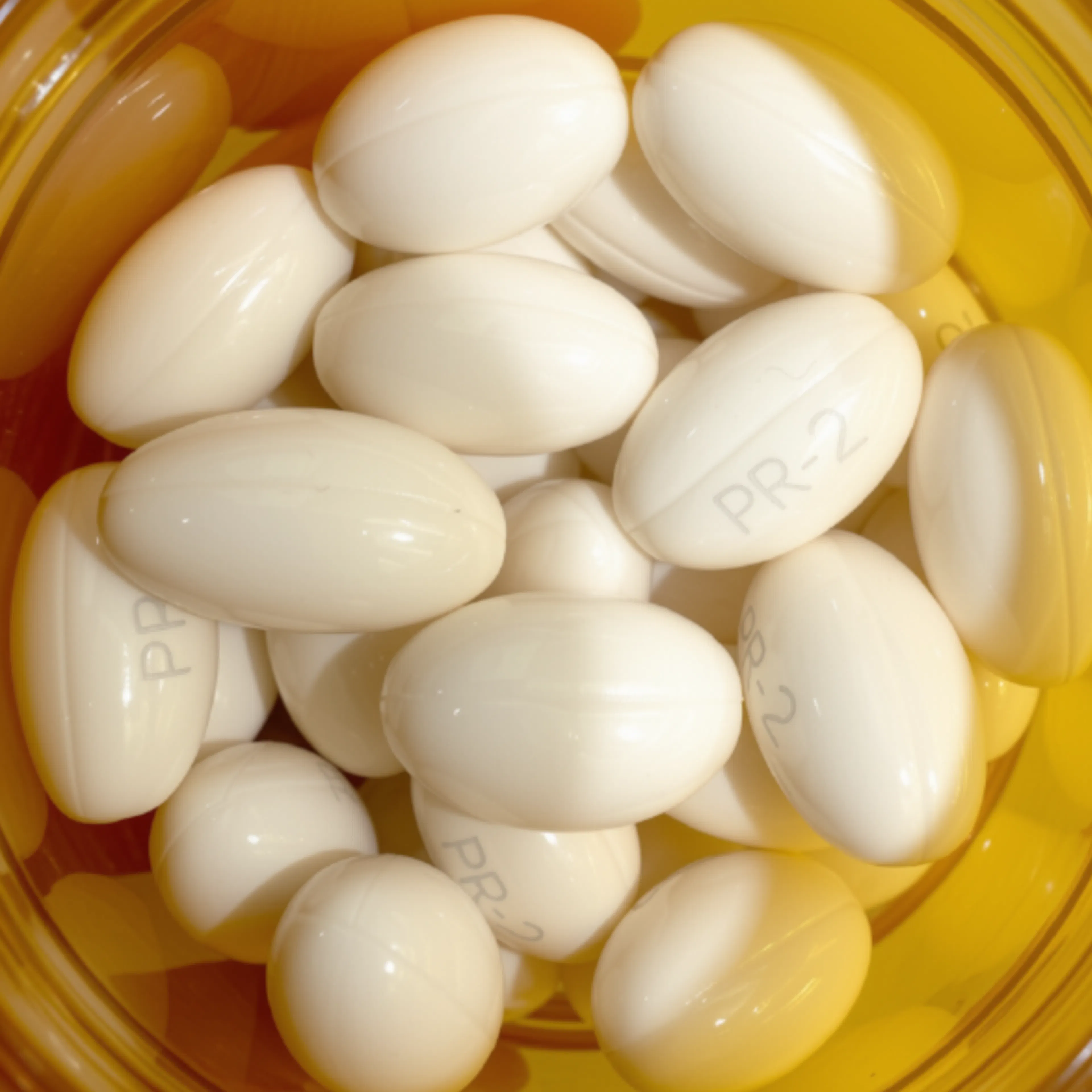 A close-up image of progesterone pills in a pill bottle.