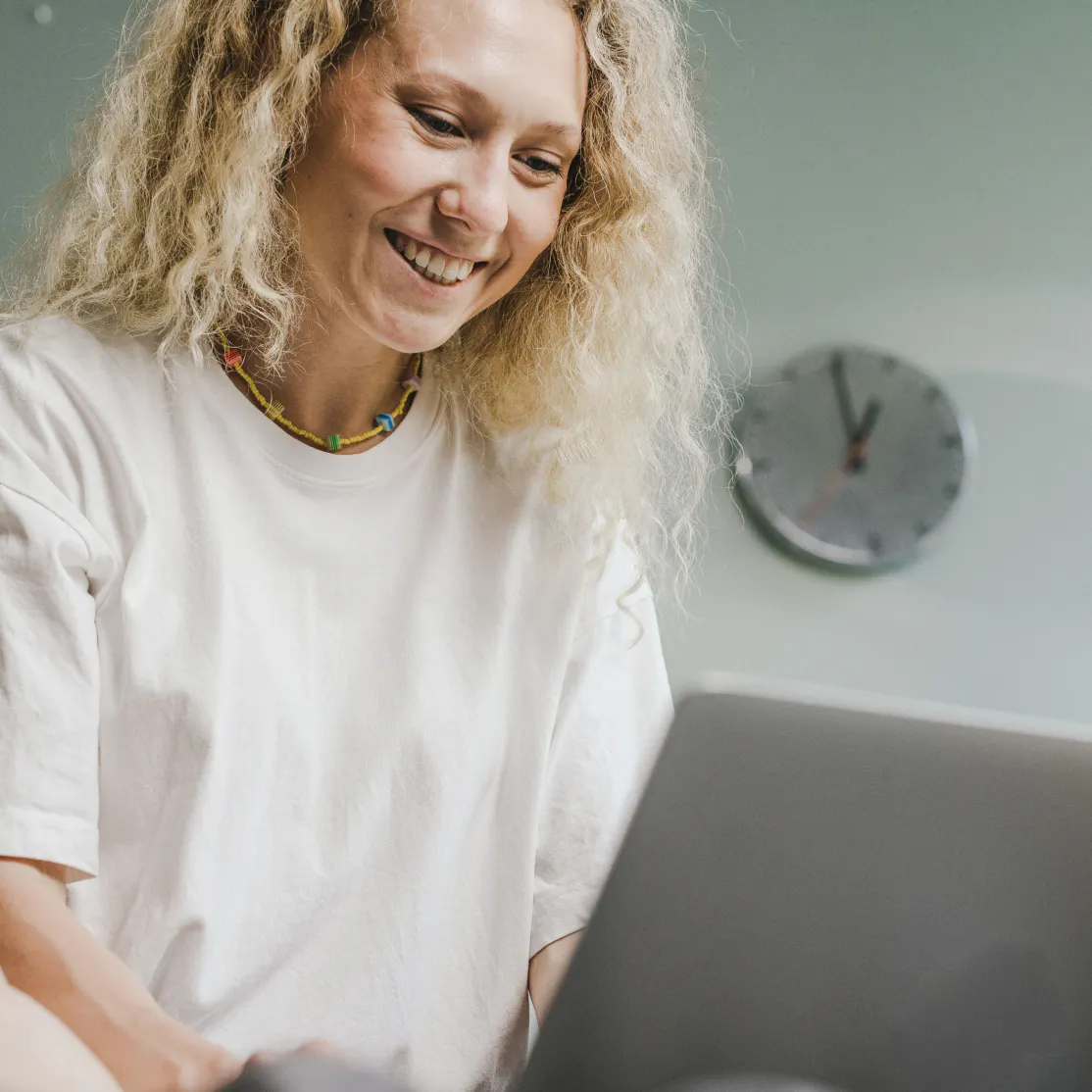 A woman in midlife looking something up on her computer.