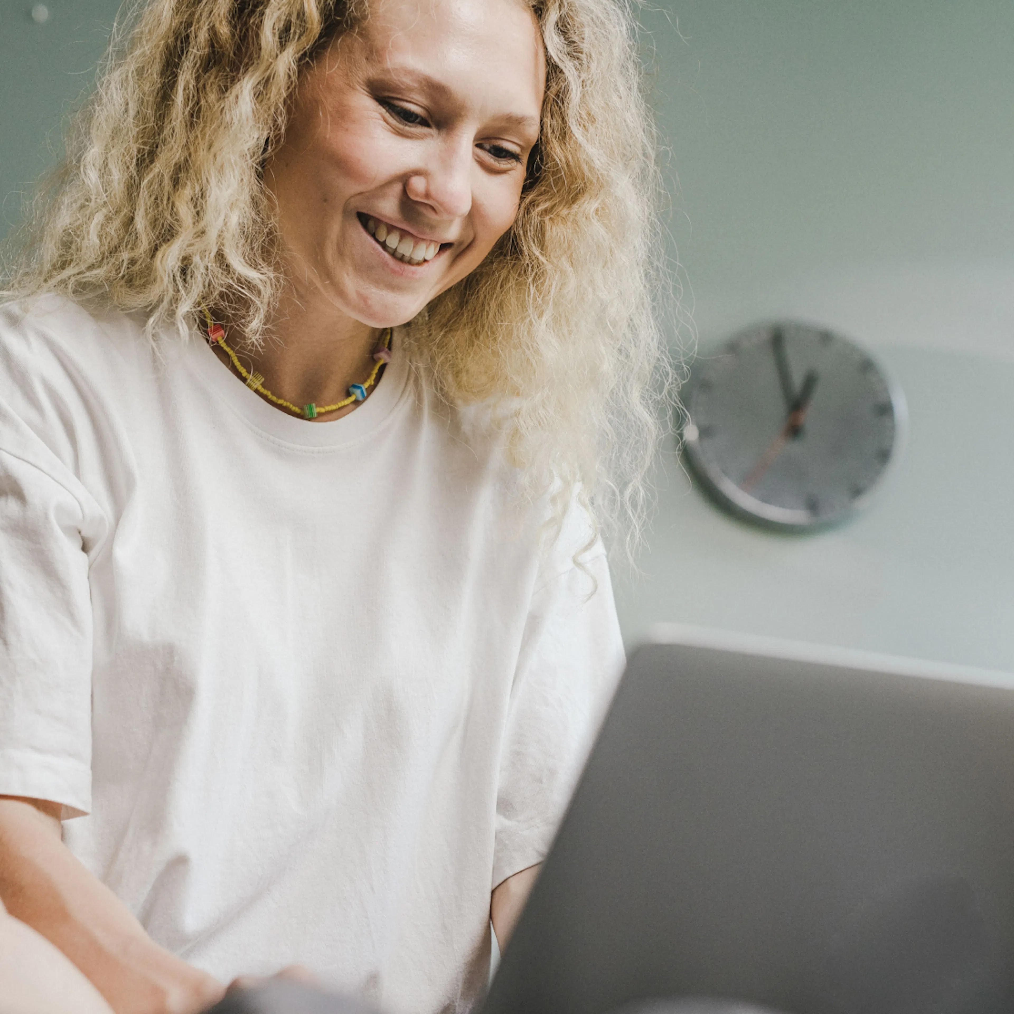 A woman in midlife looking something up on her computer.