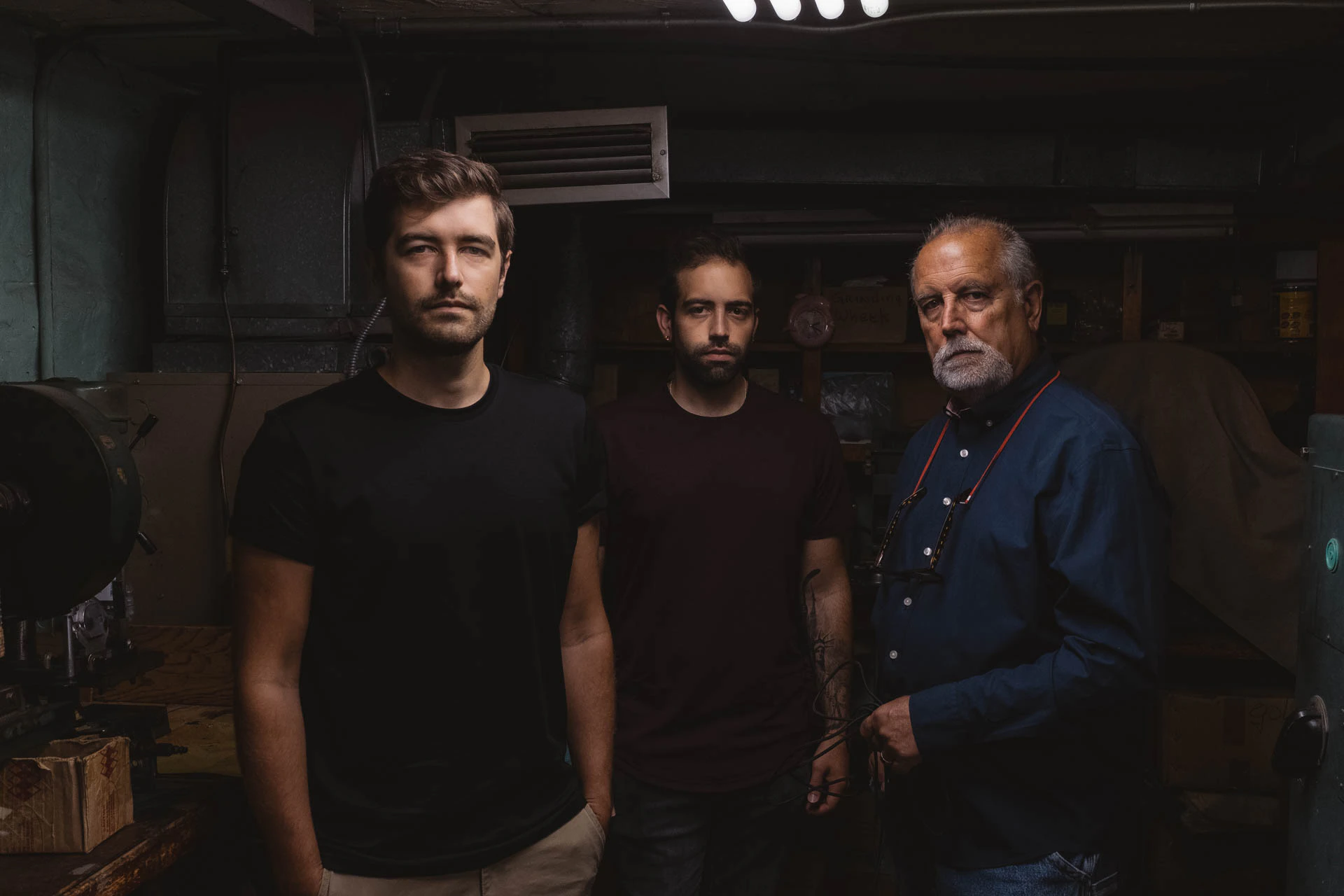 3 men standing facing the camera
