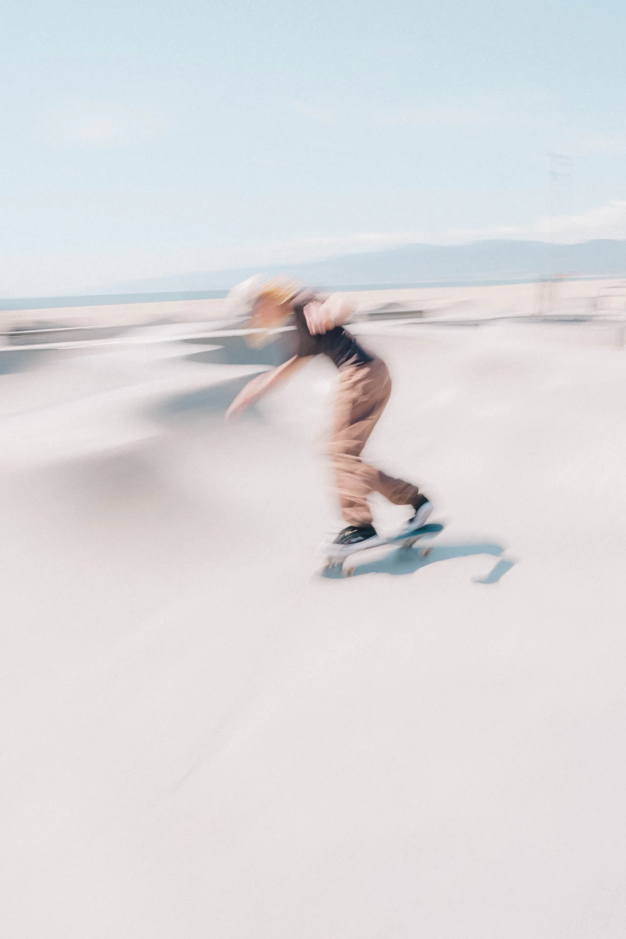 Venice Beach skateboarder in motion on a sunny day by the beach