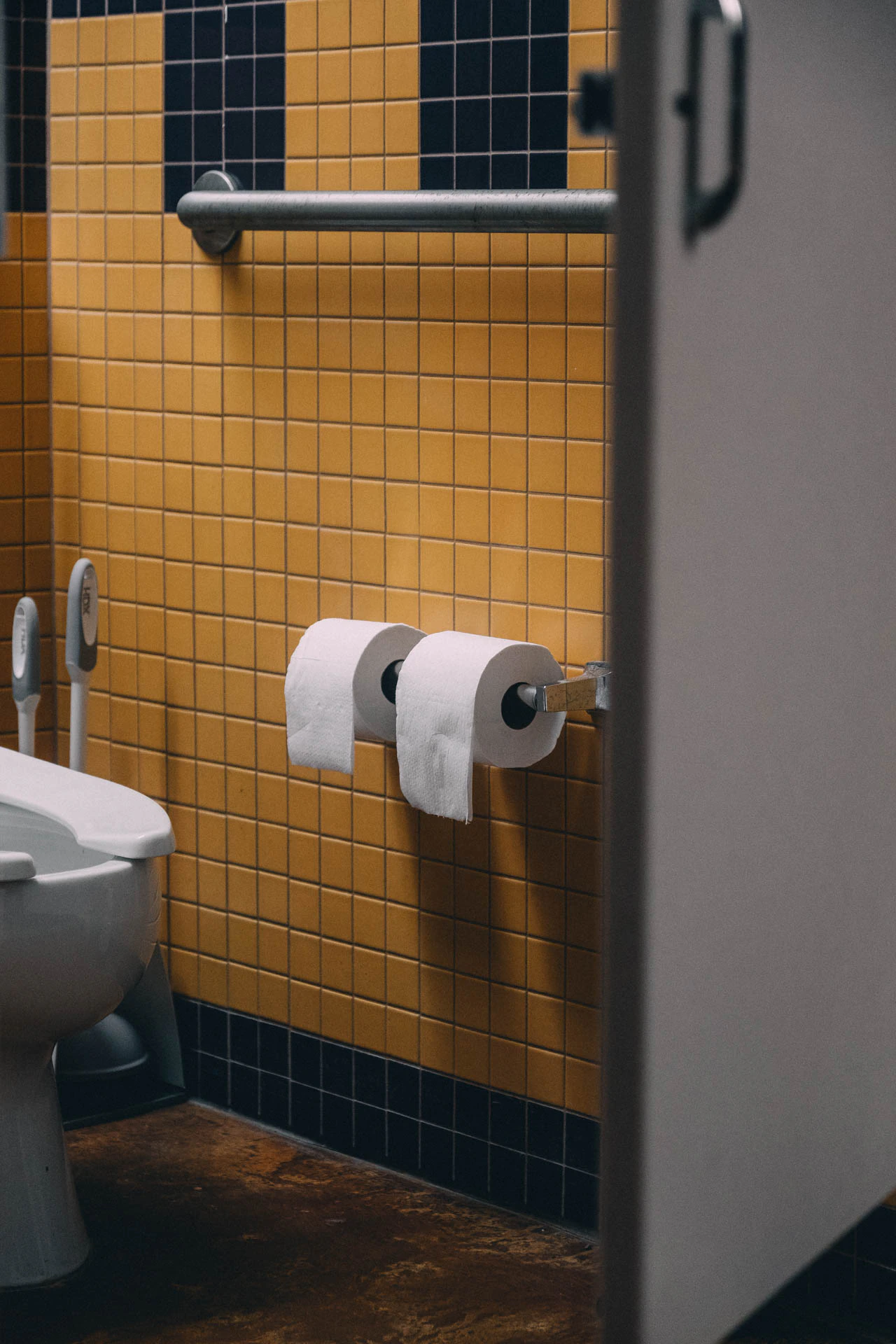 Two rolls of toilet paper in a yellow bathroom. Bookstore Bathroom #01 from Jonathan Grado's Hold Down to Flush.