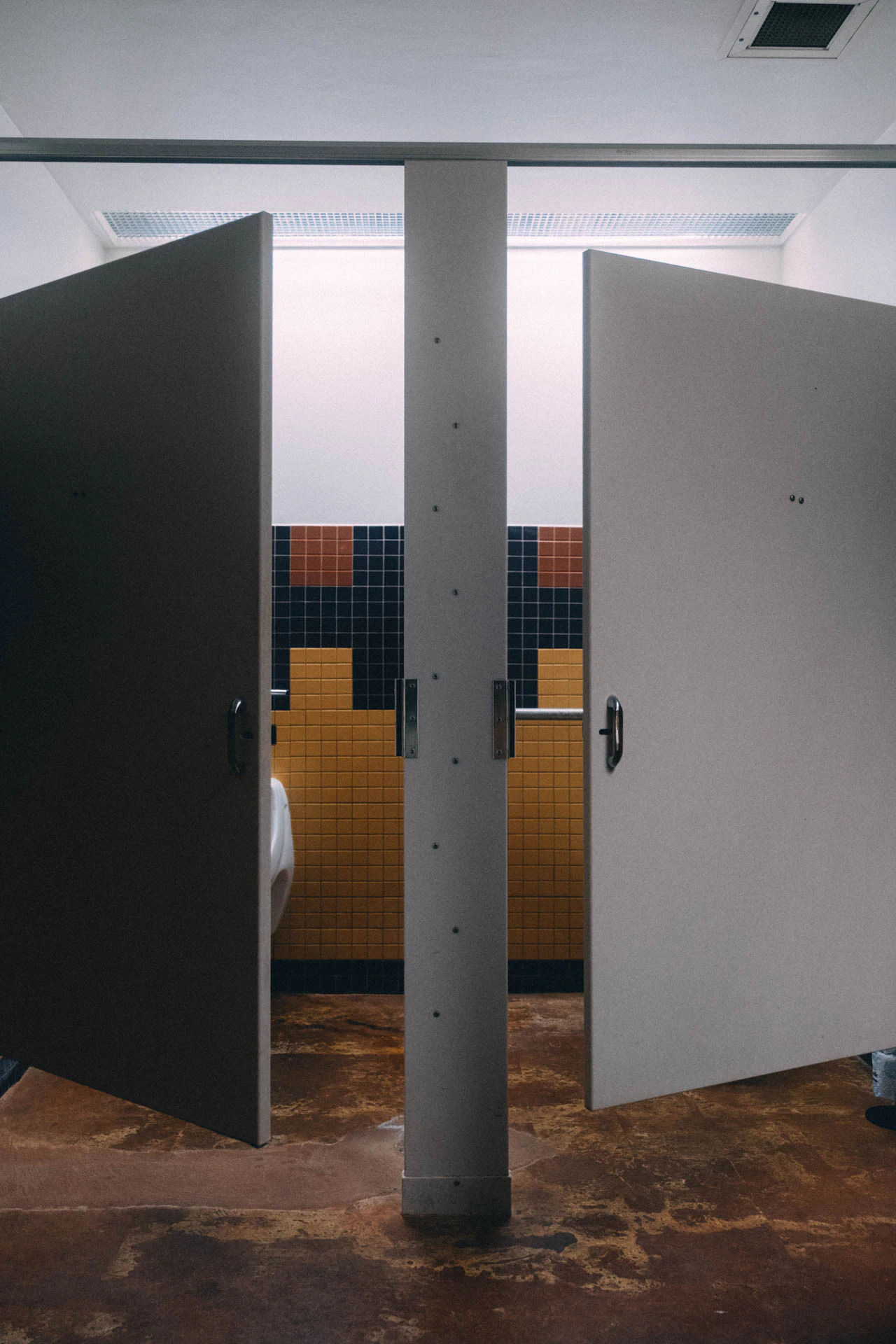 Two stalls slightly open in a bathroom. Bookstore Bathroom #02 from Jonathan Grado's Hold Down to Flush.