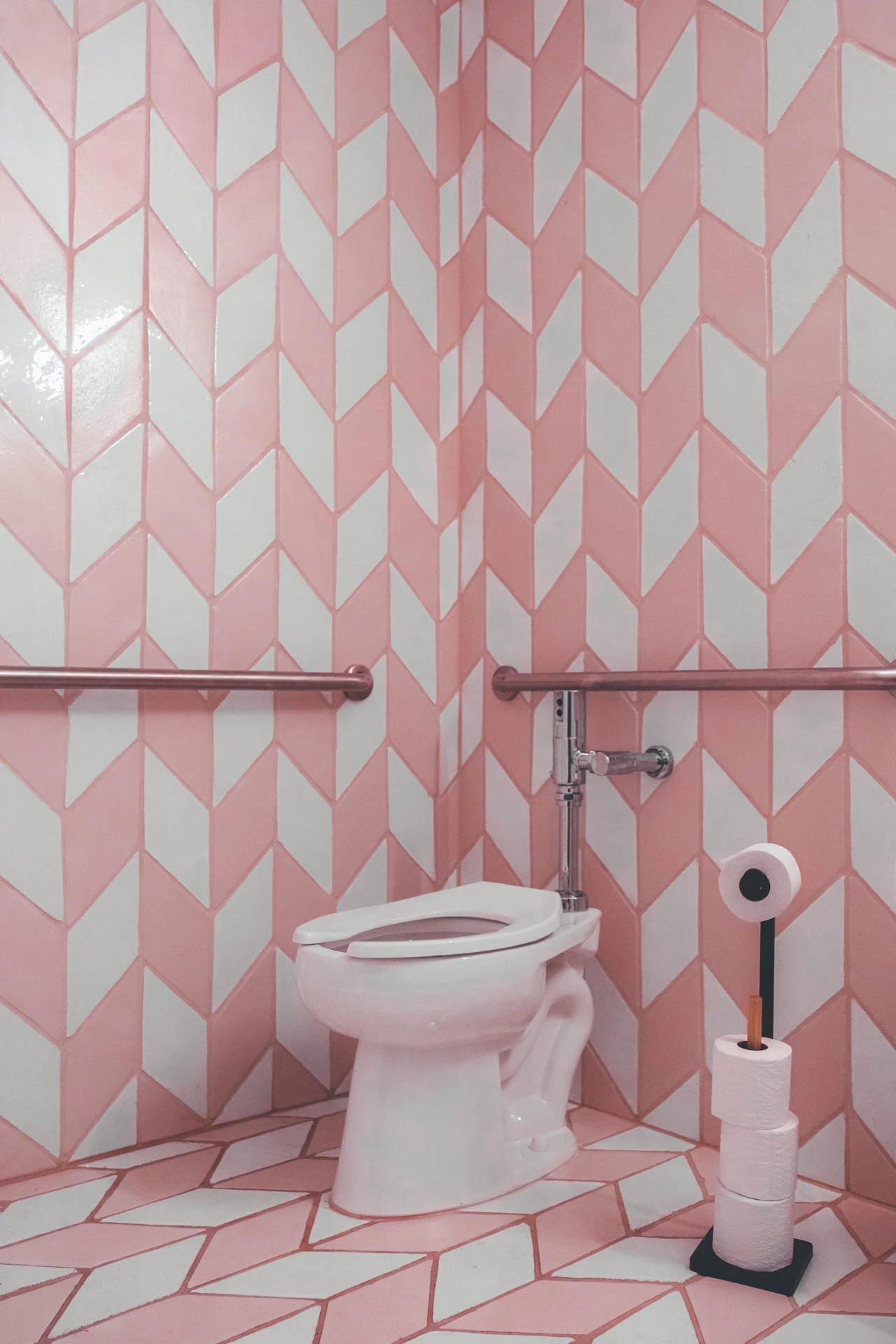 Cotton candy bathroom with pink and white diamond tile lining the walls. Cotton Candy Bathroom from Jonathan Grado's Hold Down to Flush.