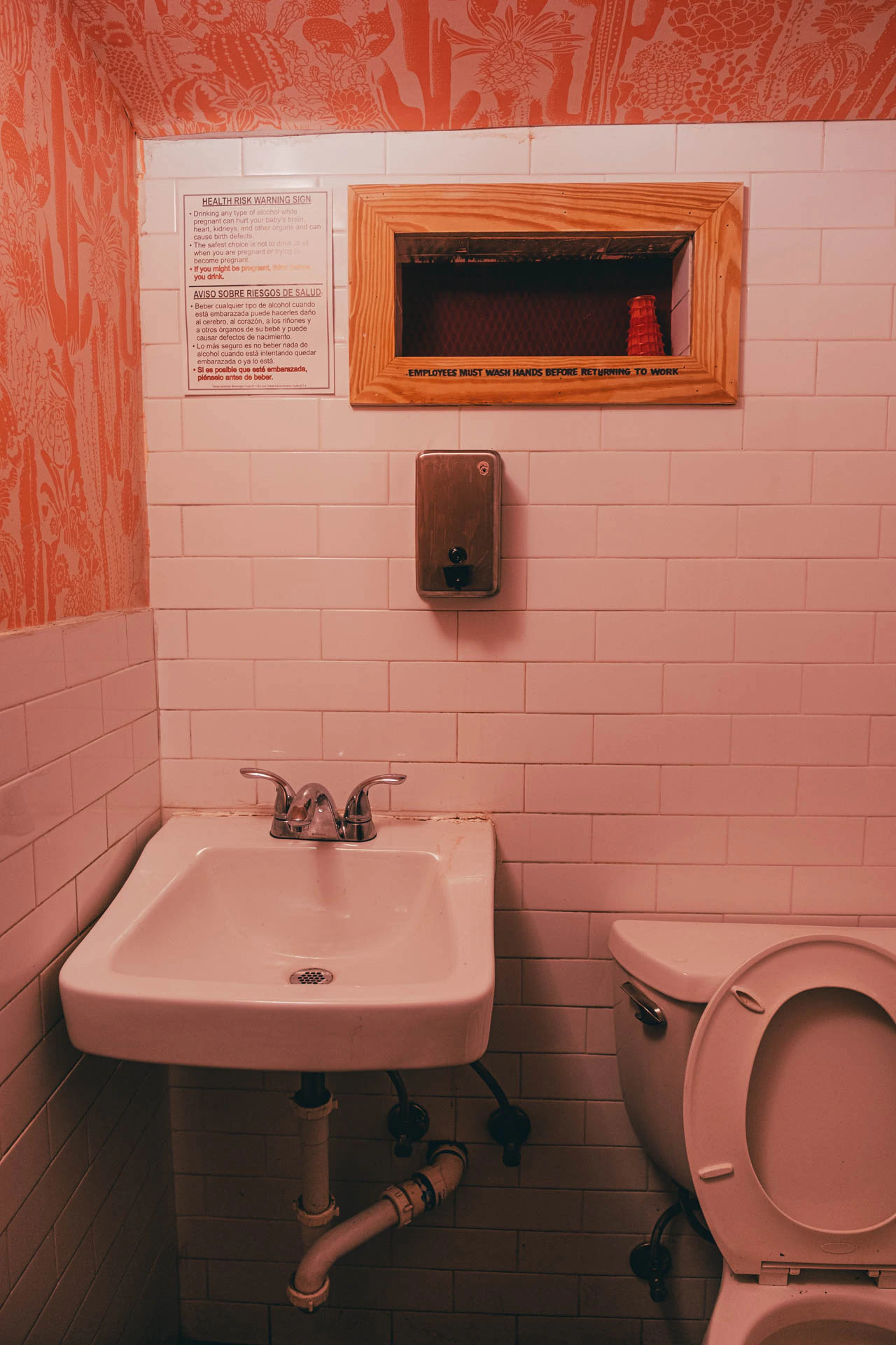 A sink in an orange bathroom. La holly #02 from Jonathan Grado's Hold Down to Flush.