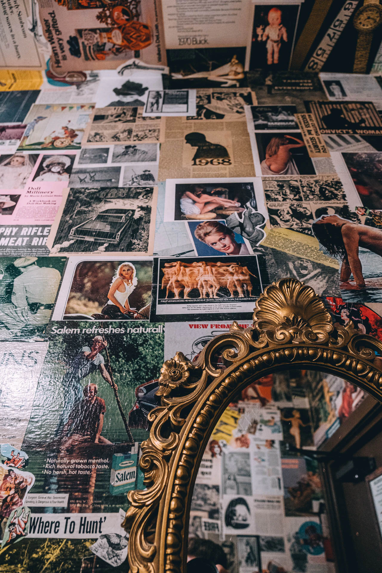Stickers and posters lining the walls of a bathroom. Mama Dearest from Jonathan Grado's Hold Down to Flush.