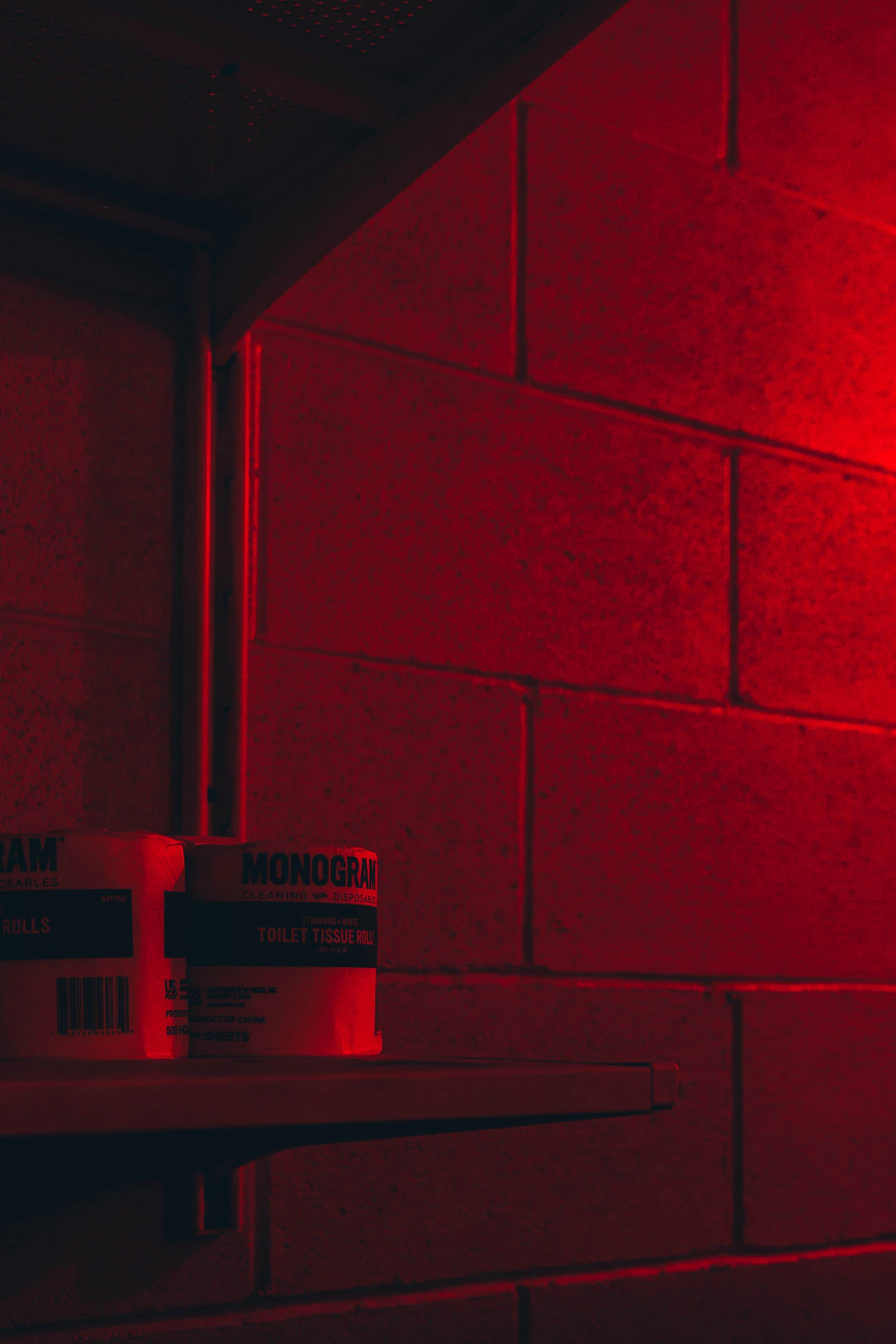 Toilet paper in a red lit bathroom at night. Red Bathroom #03 from Jonathan Grado's Hold Down to Flush.