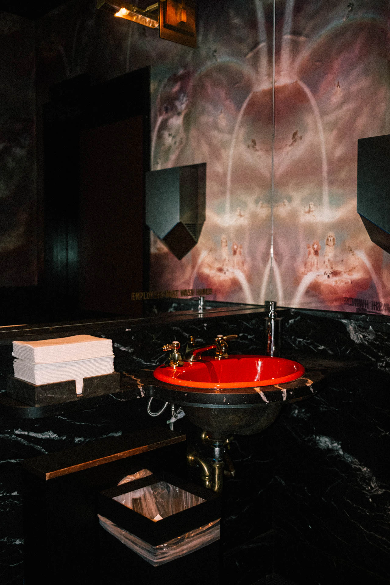 Bright red sink and napkins in a holographic wallpaper bathroom. Red Sink #01 from Jonathan Grado's Hold Down to Flush.