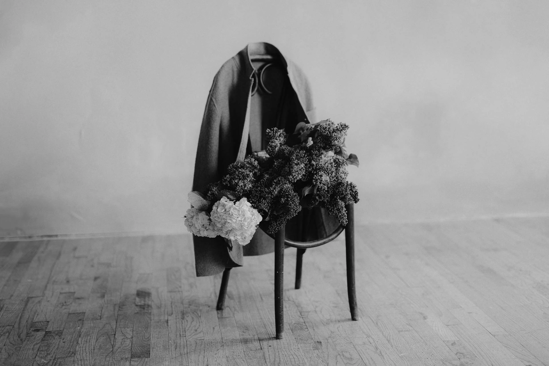 lilacs and hydrangeas flower bouquet on chair with felted jacket