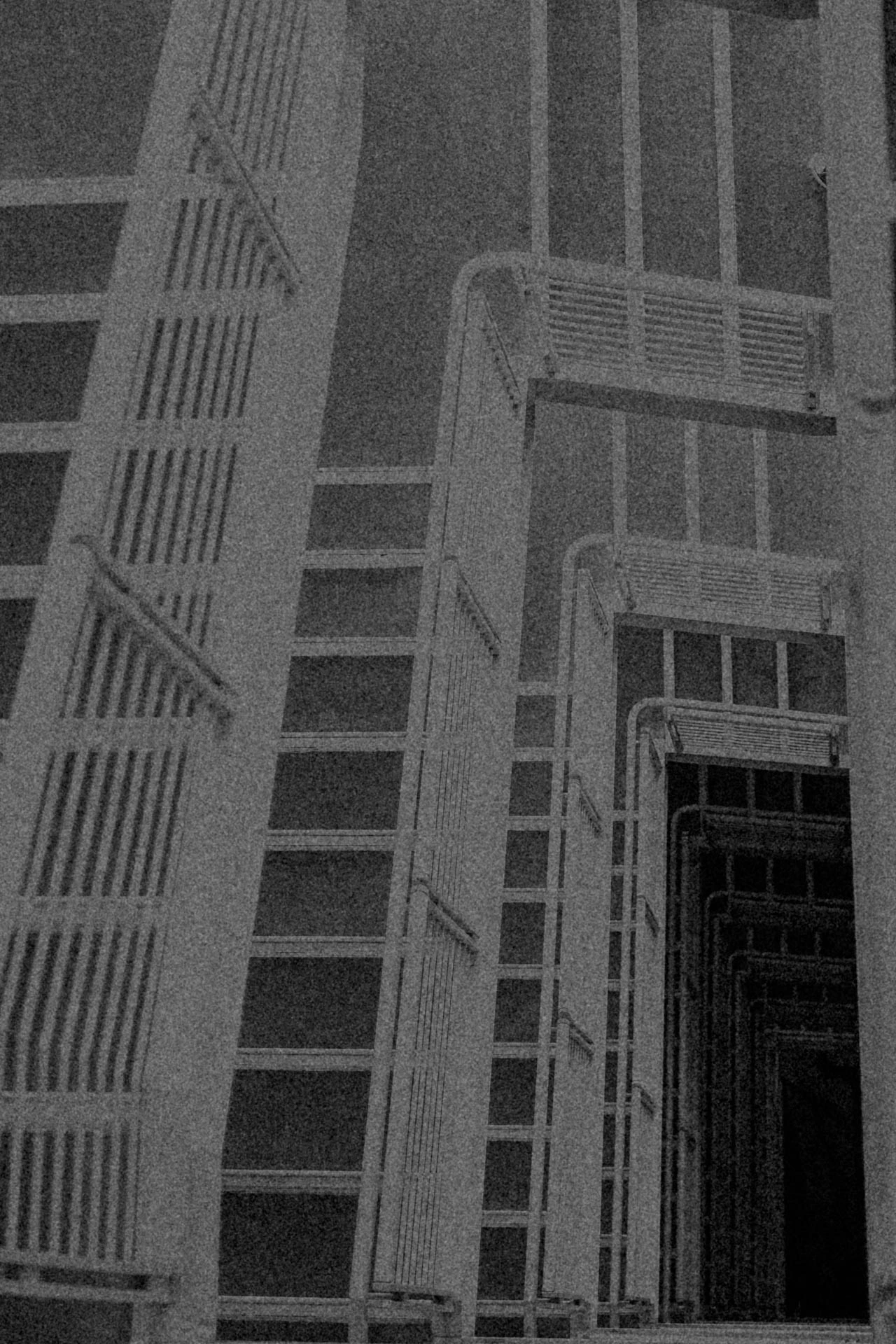 Endless stairs leading downwards in black and white. Catch a Flight from Jonathan Grado's Dirty Static.