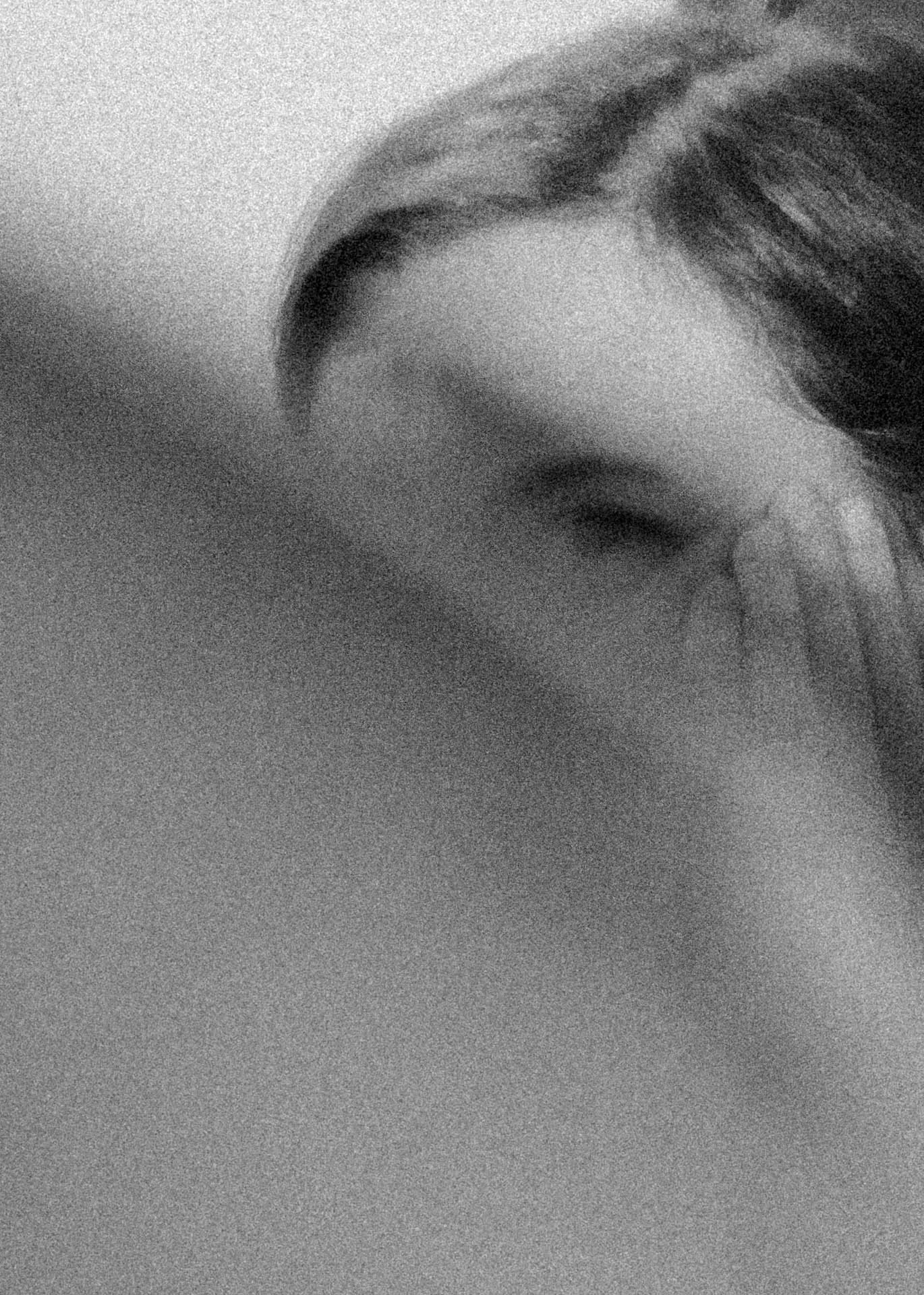 A woman looking behind a shoulder showing only one eye. Heirlooms from Jonathan Grado's Dirty Static.