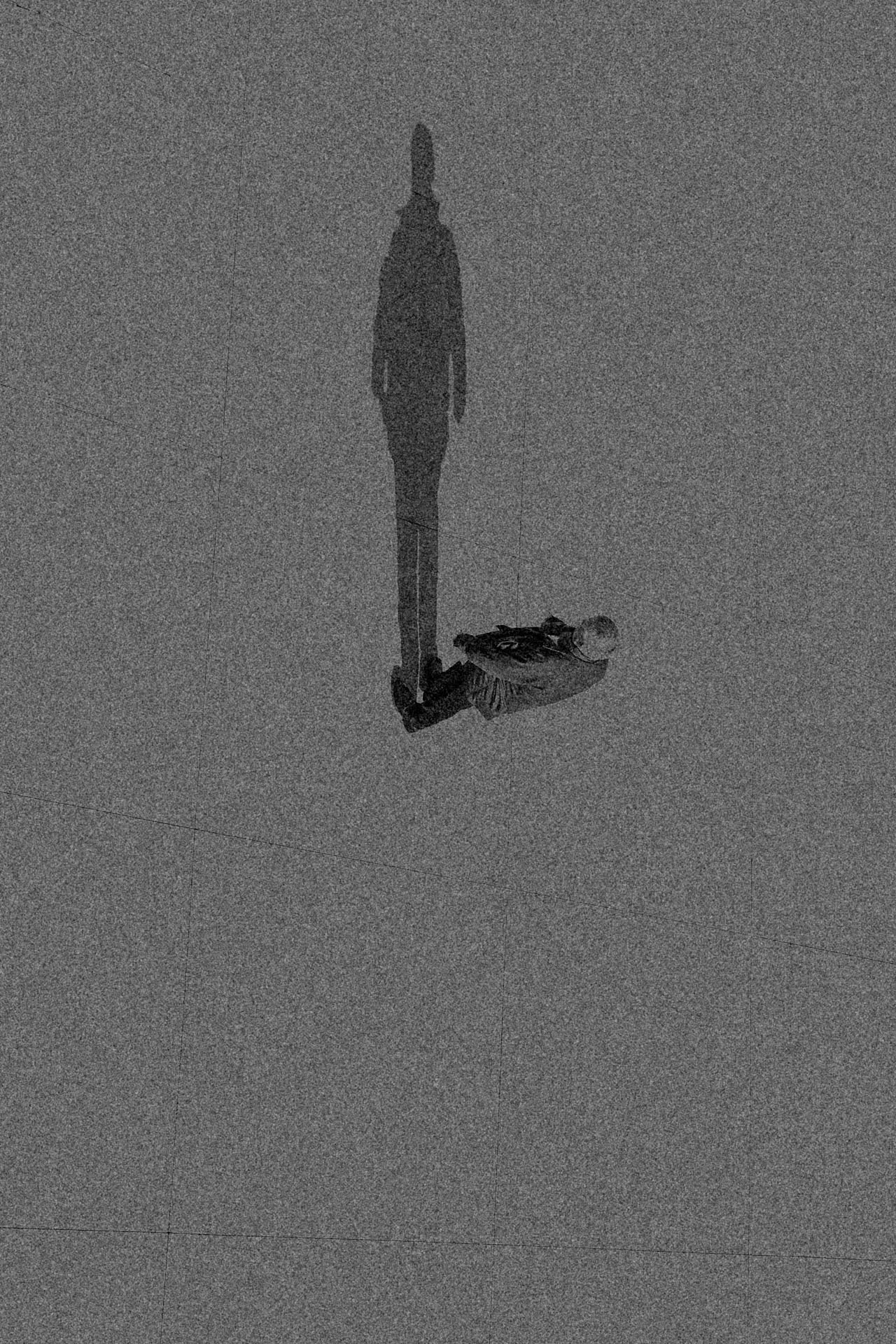 Man walking vertically up a grainy building in black and white. Noon from Jonathan Grado's Dirty Static.