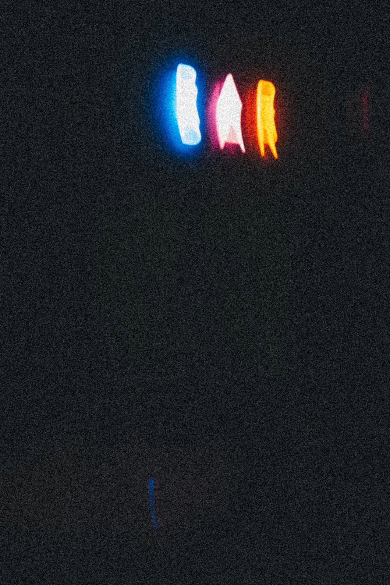 Blue, orange, and red neon sign spelling BAR with motion. Right Before from Jonathan Grado's Dirty Static.