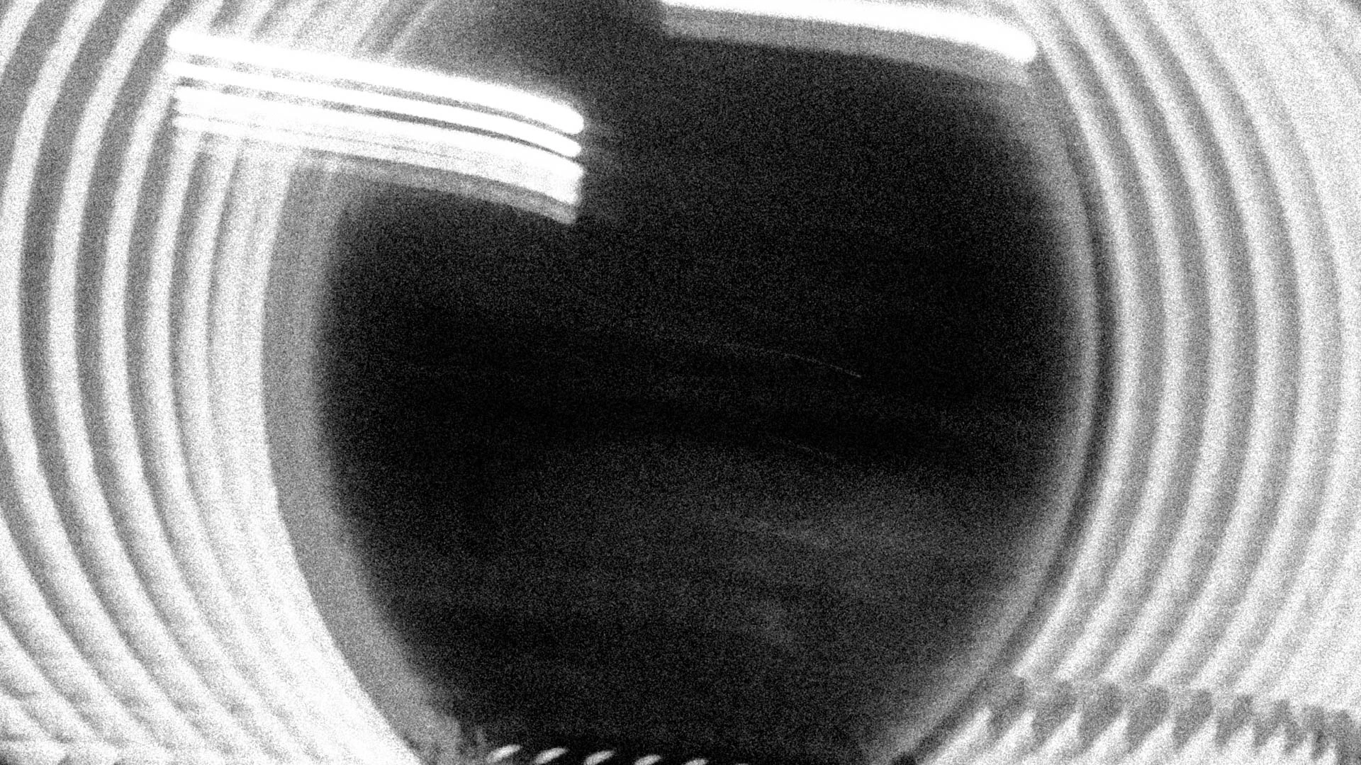Long exposure light trails on the left and right of a mirror. Abstract black and white. Urgent Waking Thought from Jonathan Grado's Dirty Static.