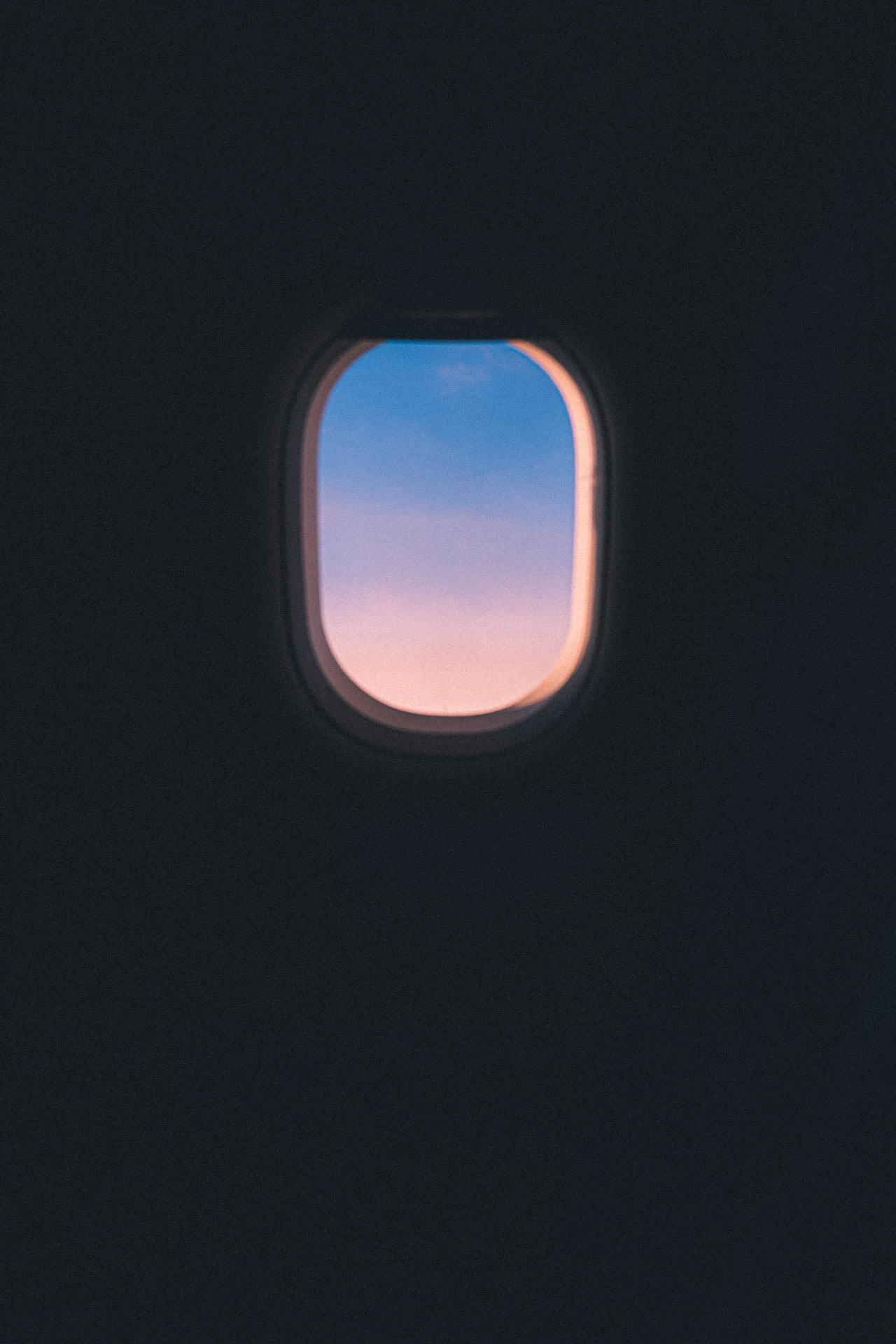 Pink and purple sunrise through an airplane window. What Is Left from Jonathan Grado's Dirty Static.