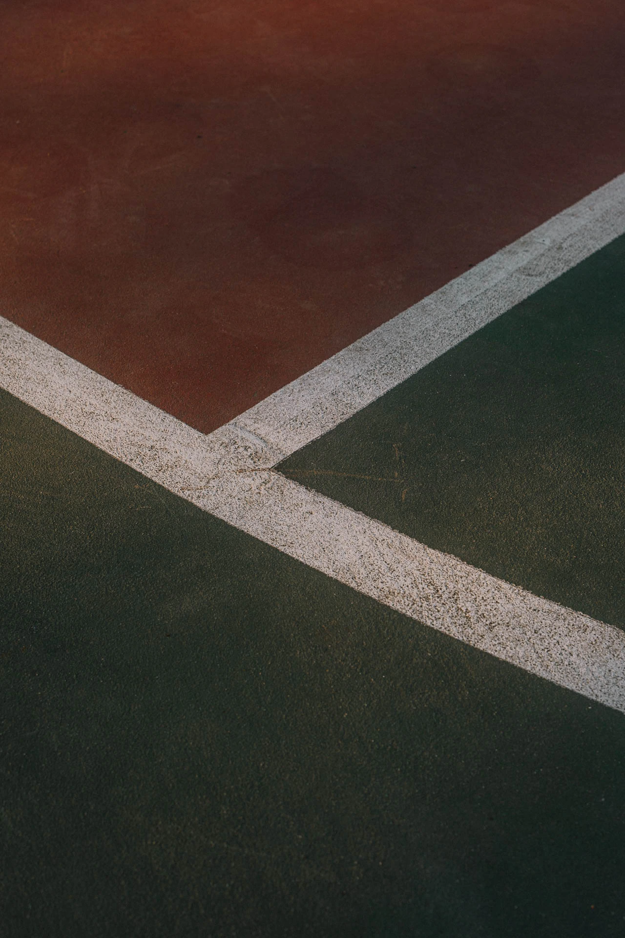 abstract green and red basketball court lines at sunset
