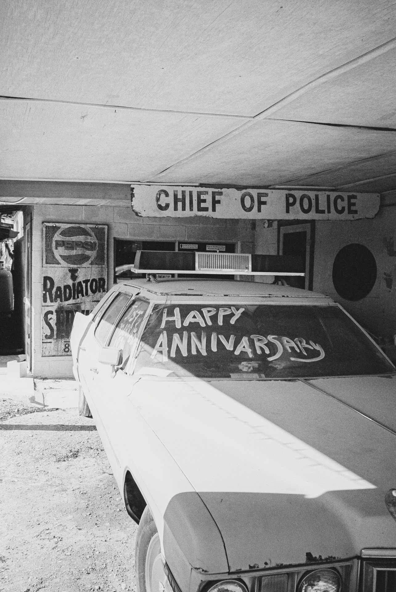 Devils Backbone Tavern car that says happy anniversary on black and white film