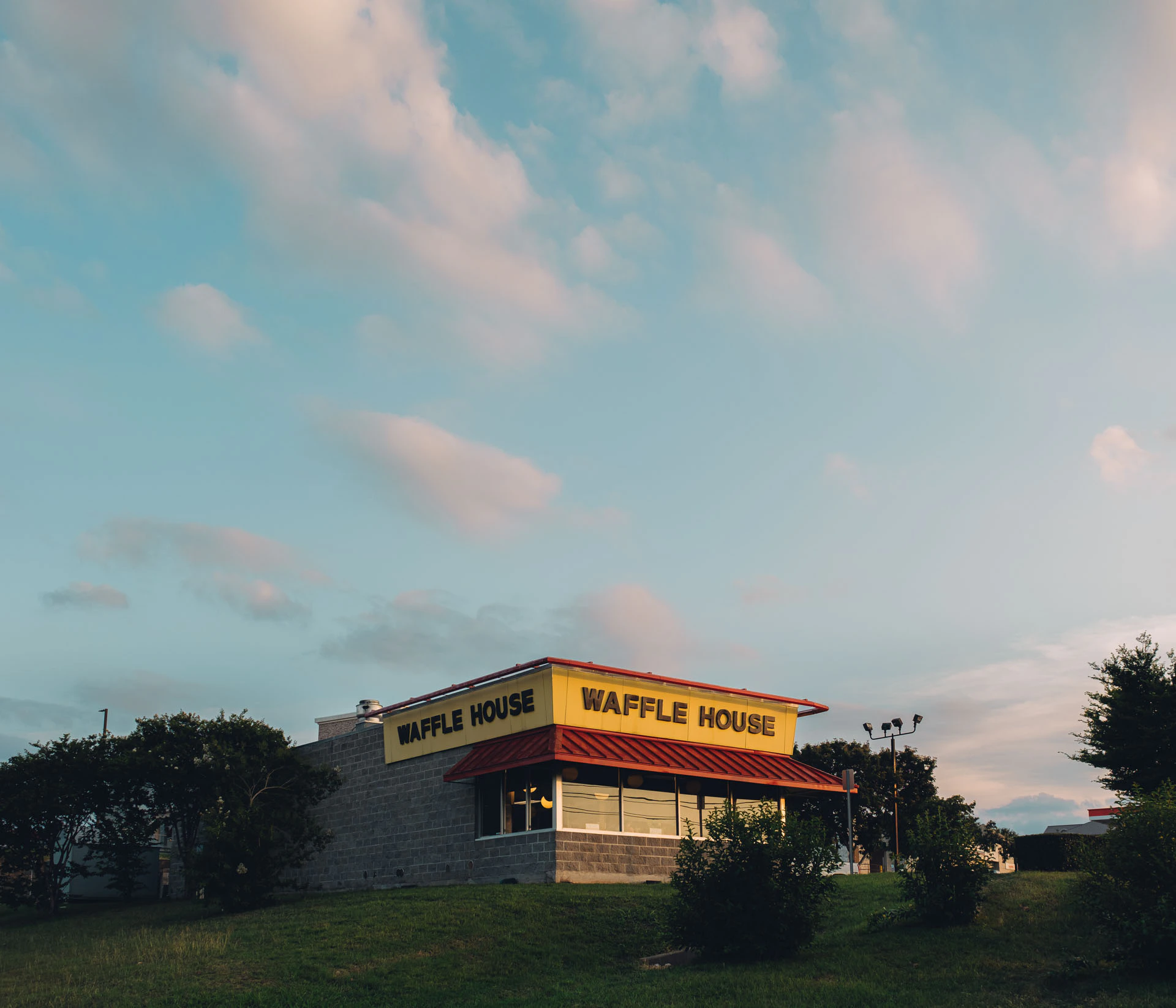Waffle House at Sunset on a grassy hill in Texas